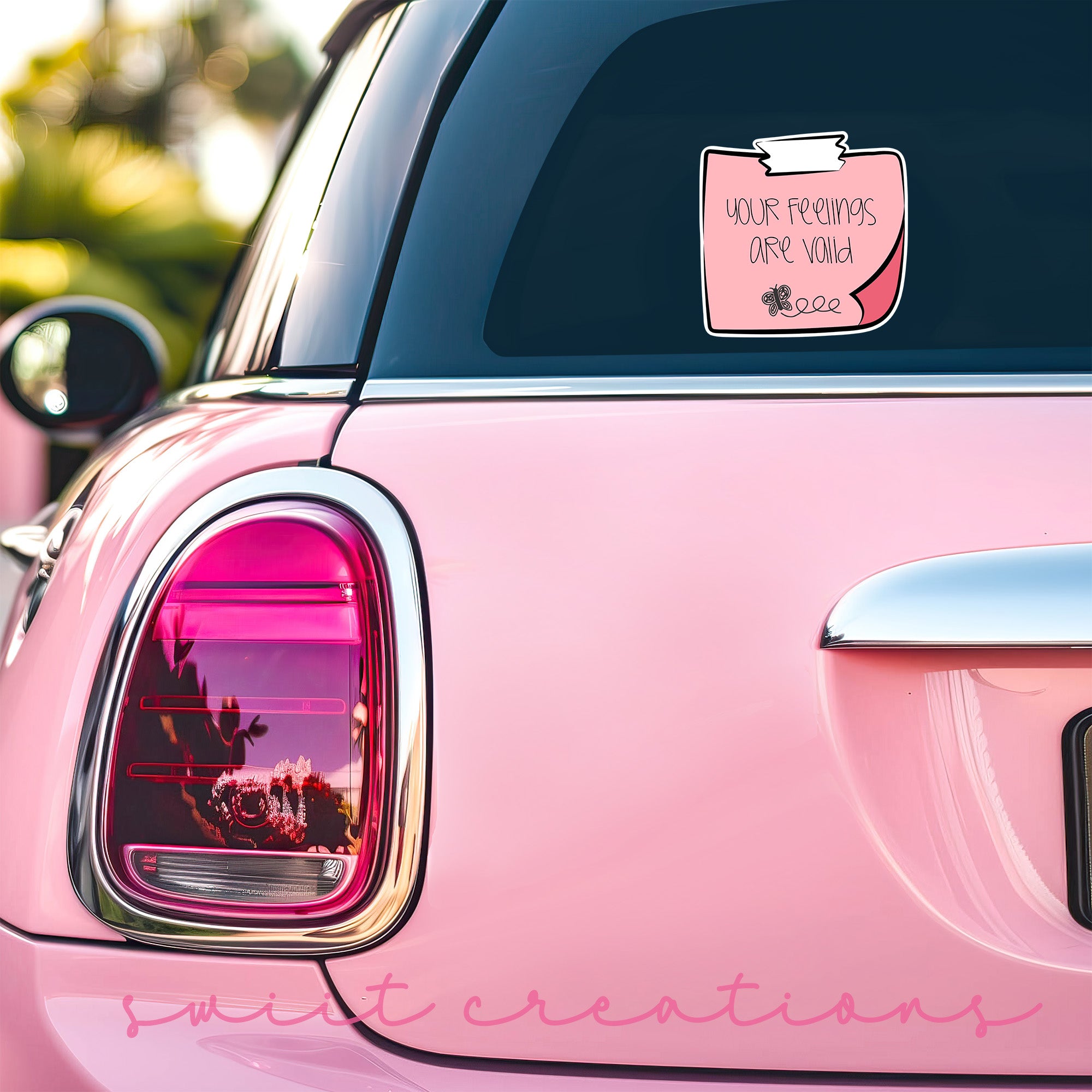 a pink car with a pink sticker on it