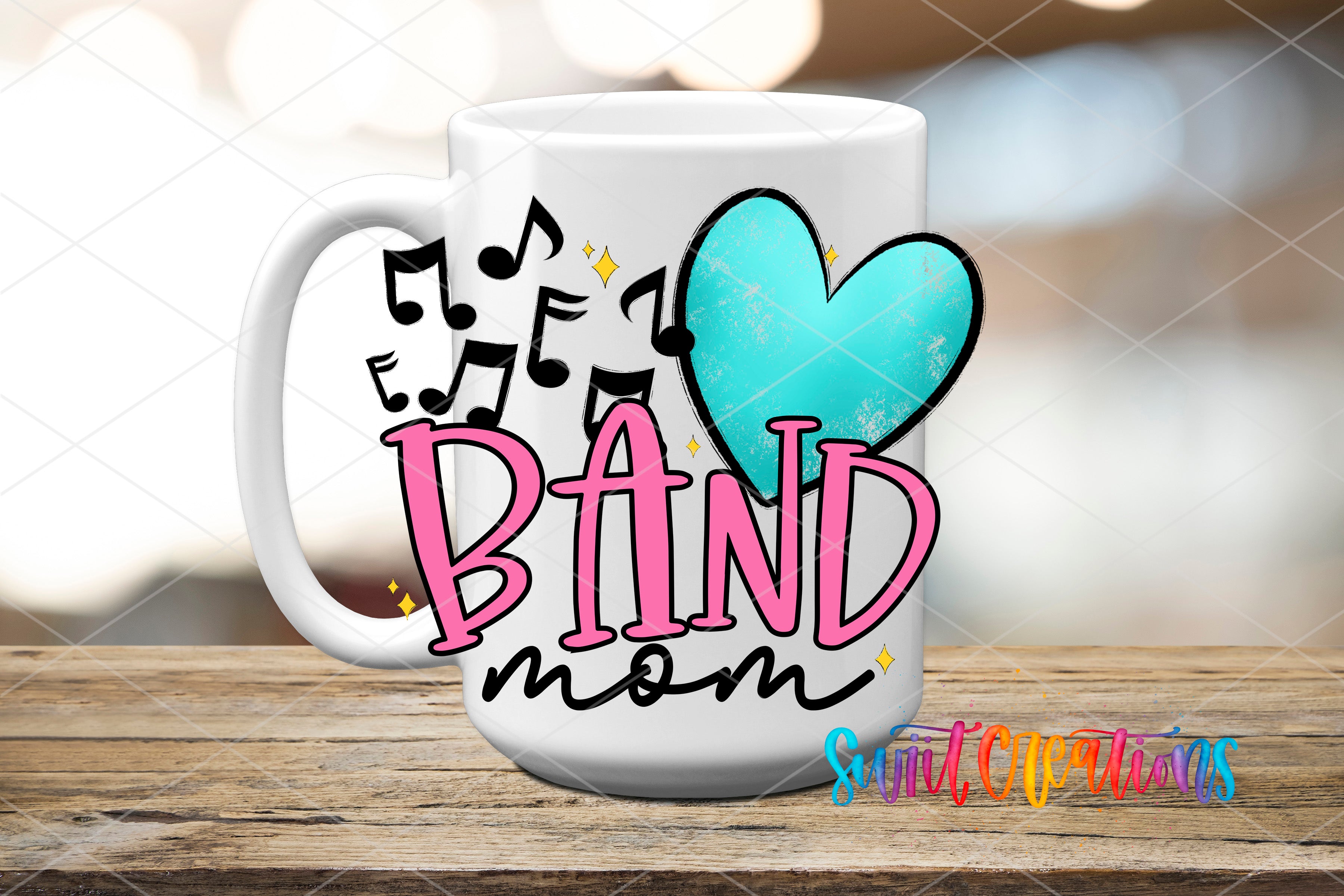 A white mug with the text "BAND mom" and a heart-shaped symbol, along with musical notes, is displayed on a wooden surface.
