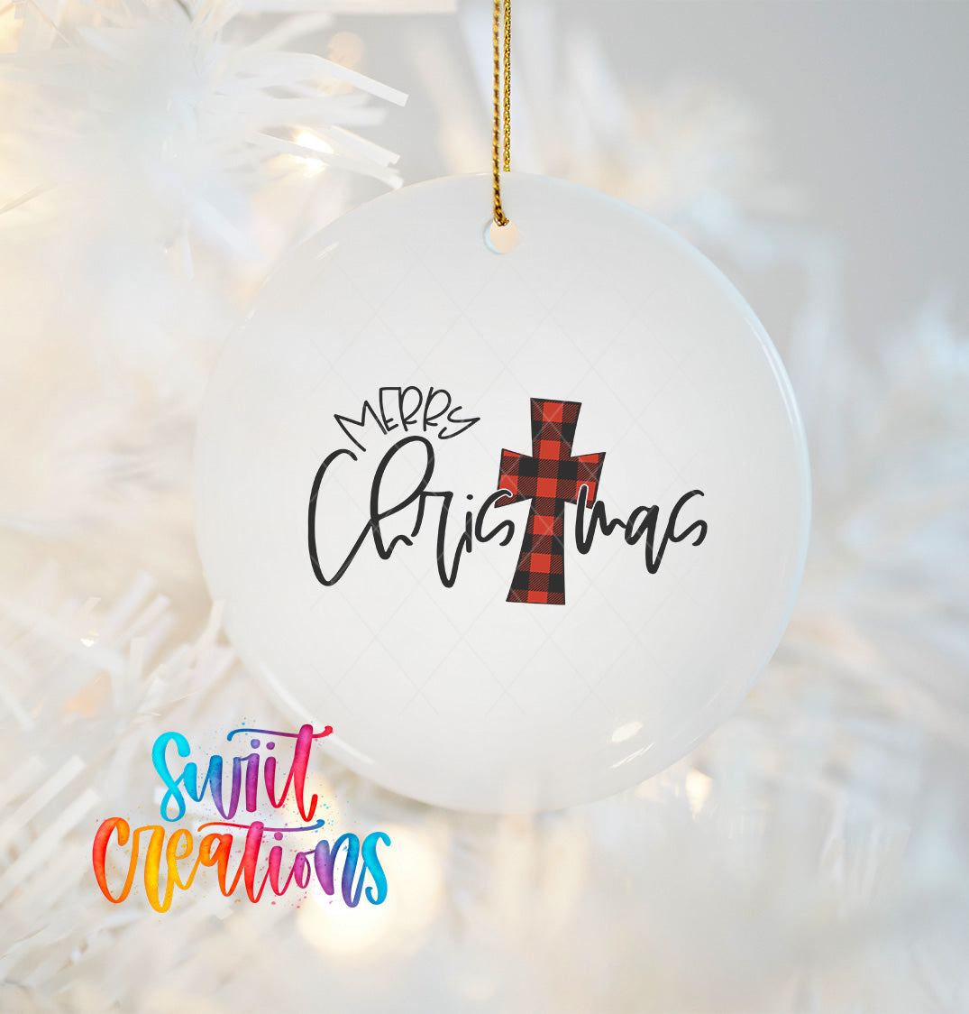 A white Christmas ornament with a red and black plaid cross design and the text "Merry Christmas" written on it.