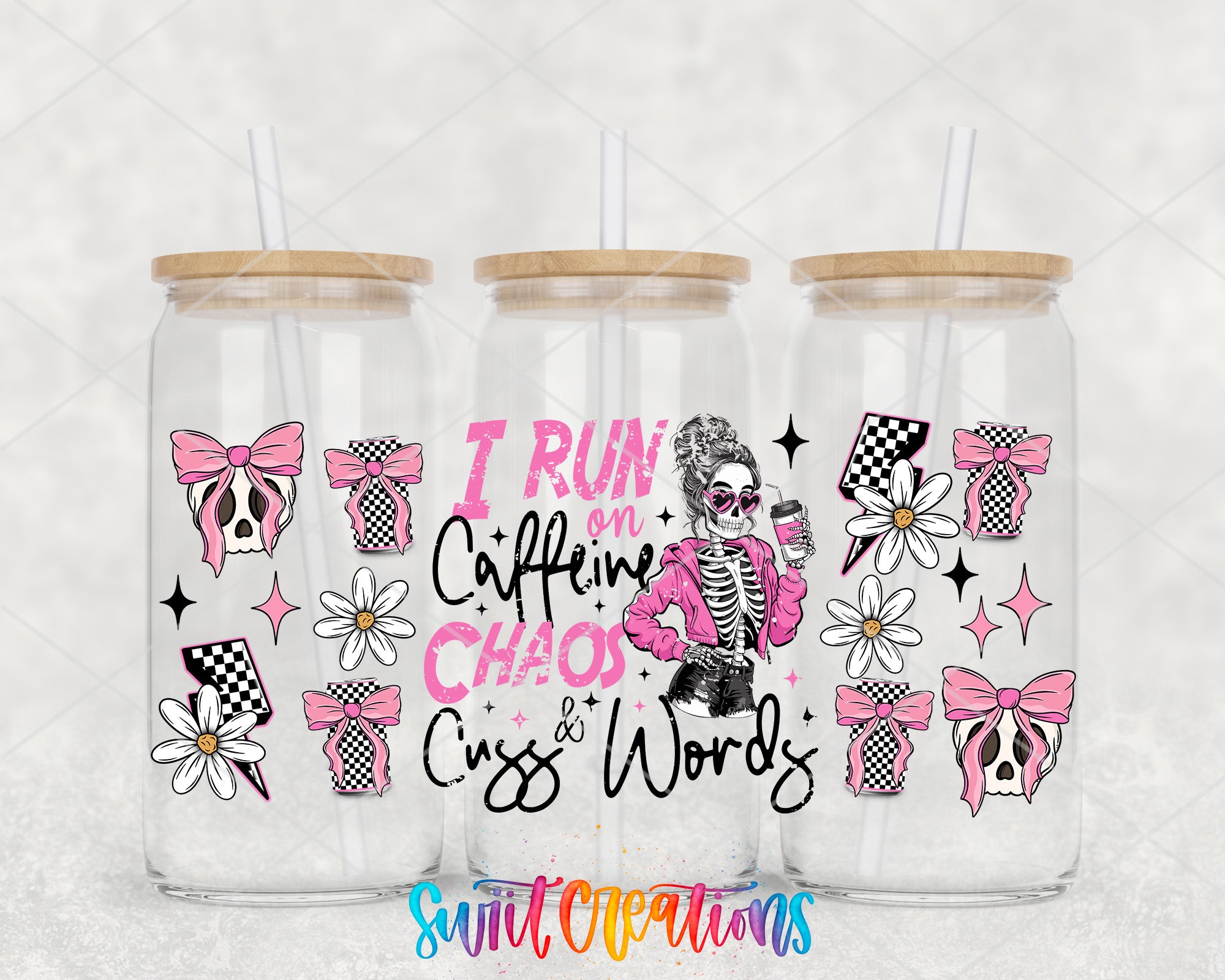 three glass tumblers with various designs and illustrations on them, including a skeleton, flowers, and bows.