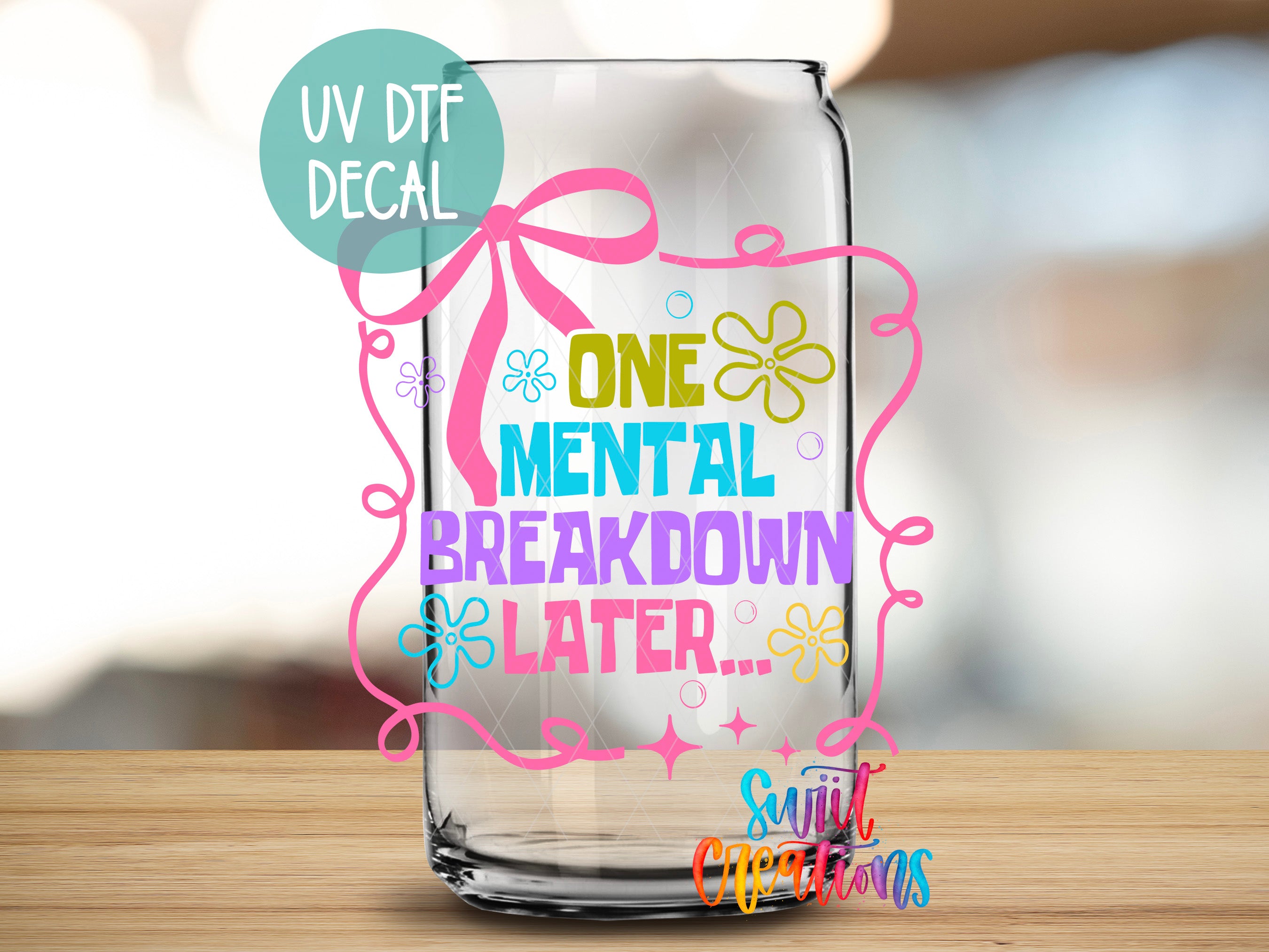 a glass jar with a colorful, decorative design and text on it.