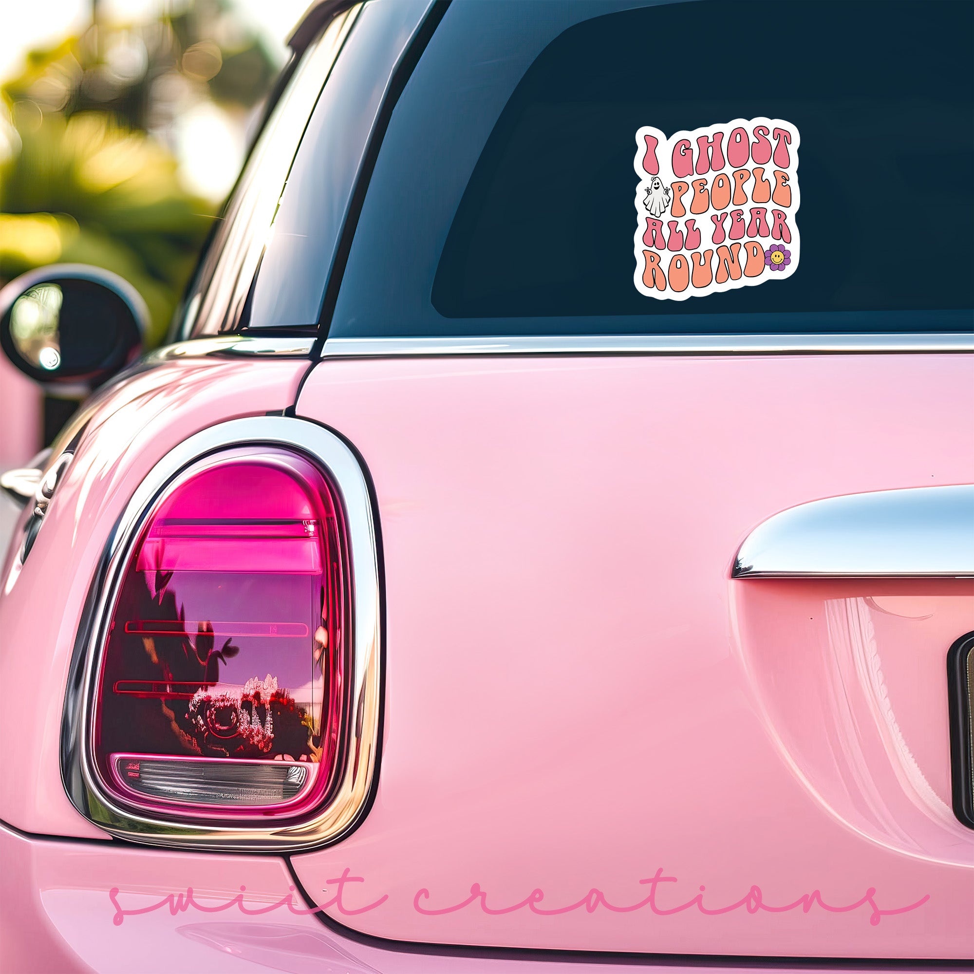 a pink car with a sticker on it