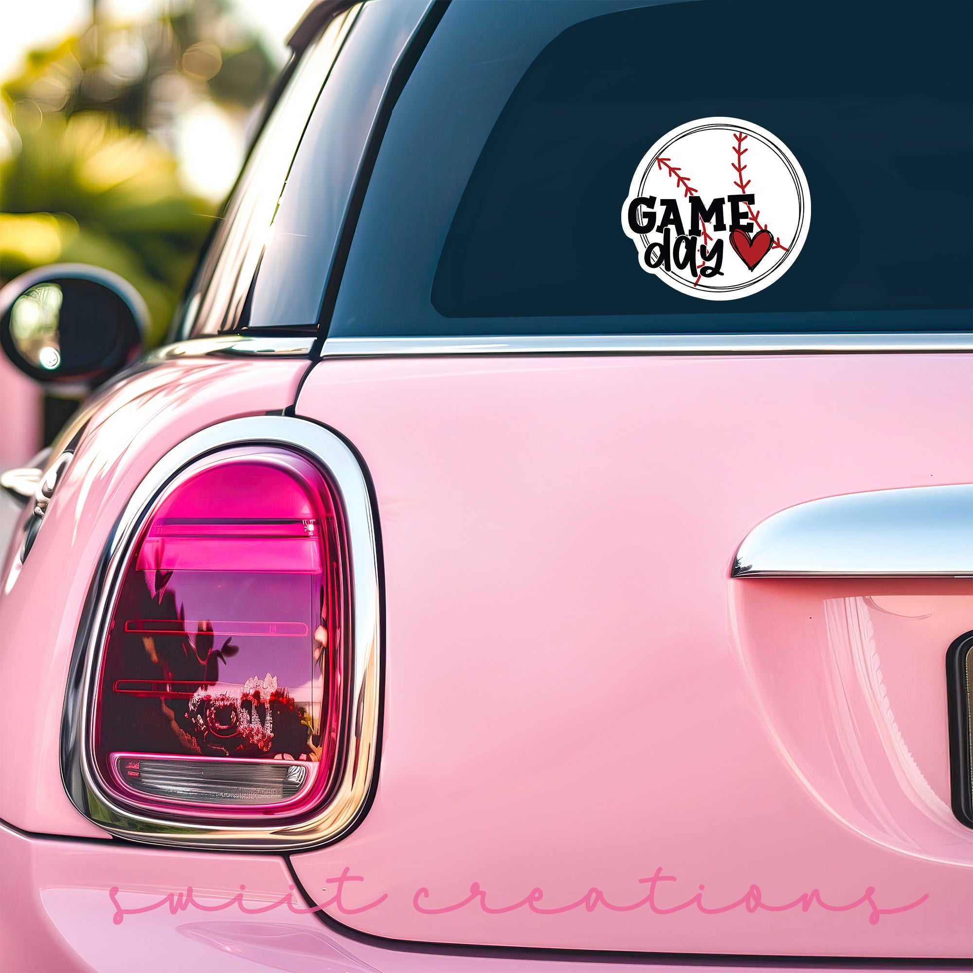 a pink car with a baseball sticker on it