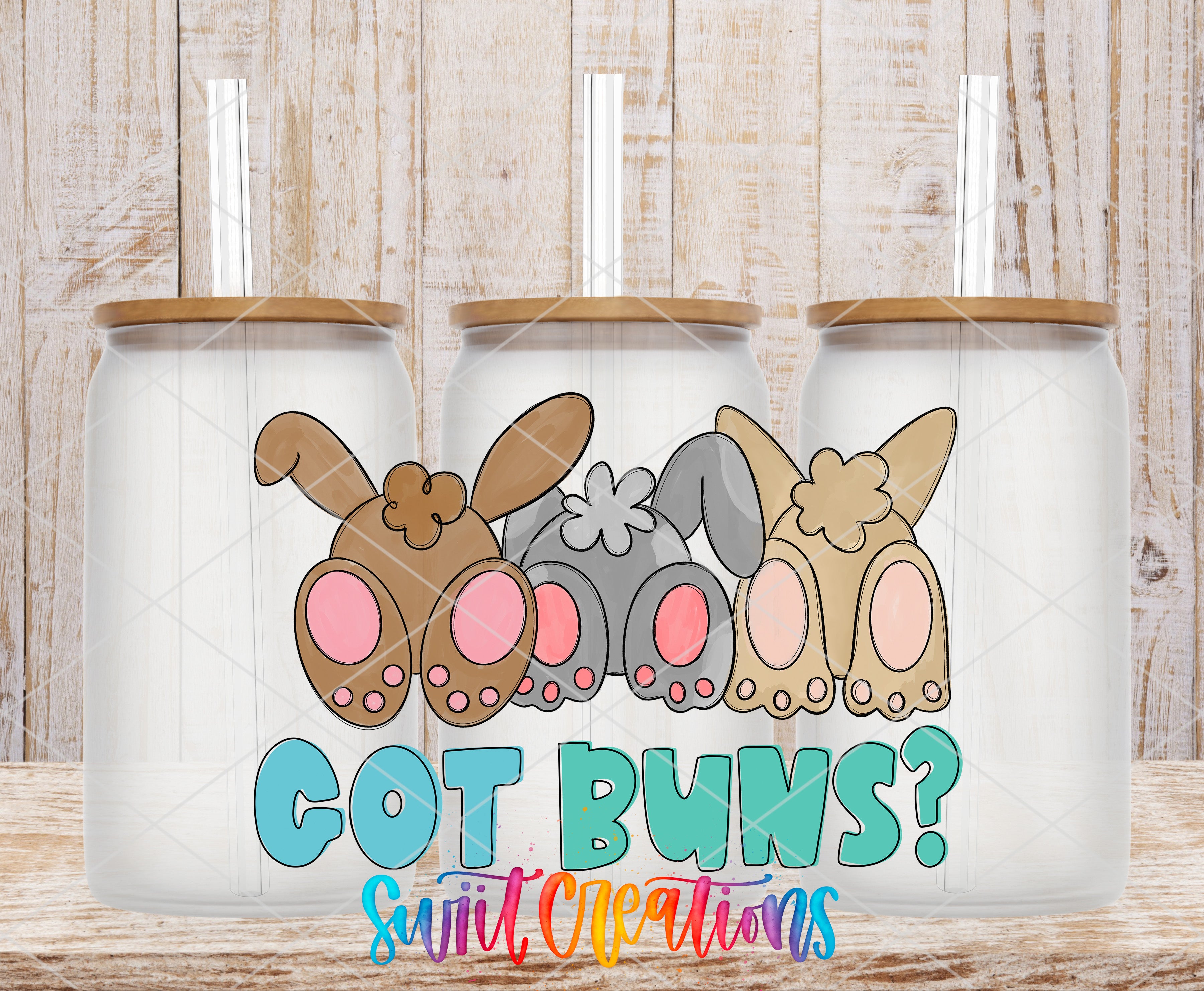A collection of three glass jars with cartoon rabbit ears and the text "GOT BUNS?" printed on them, set against a wooden background.
