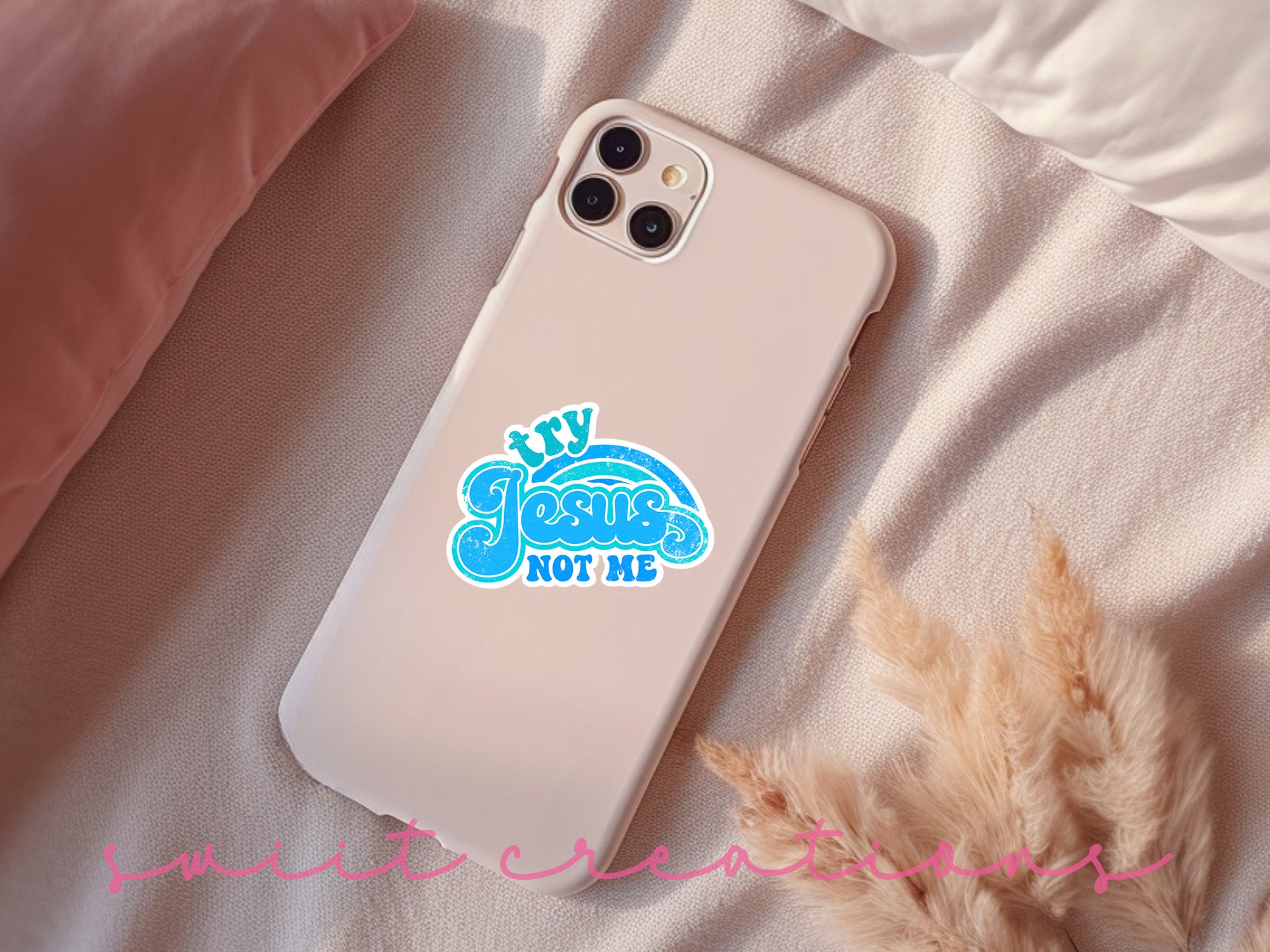a phone case with a sticker on it sitting on a bed