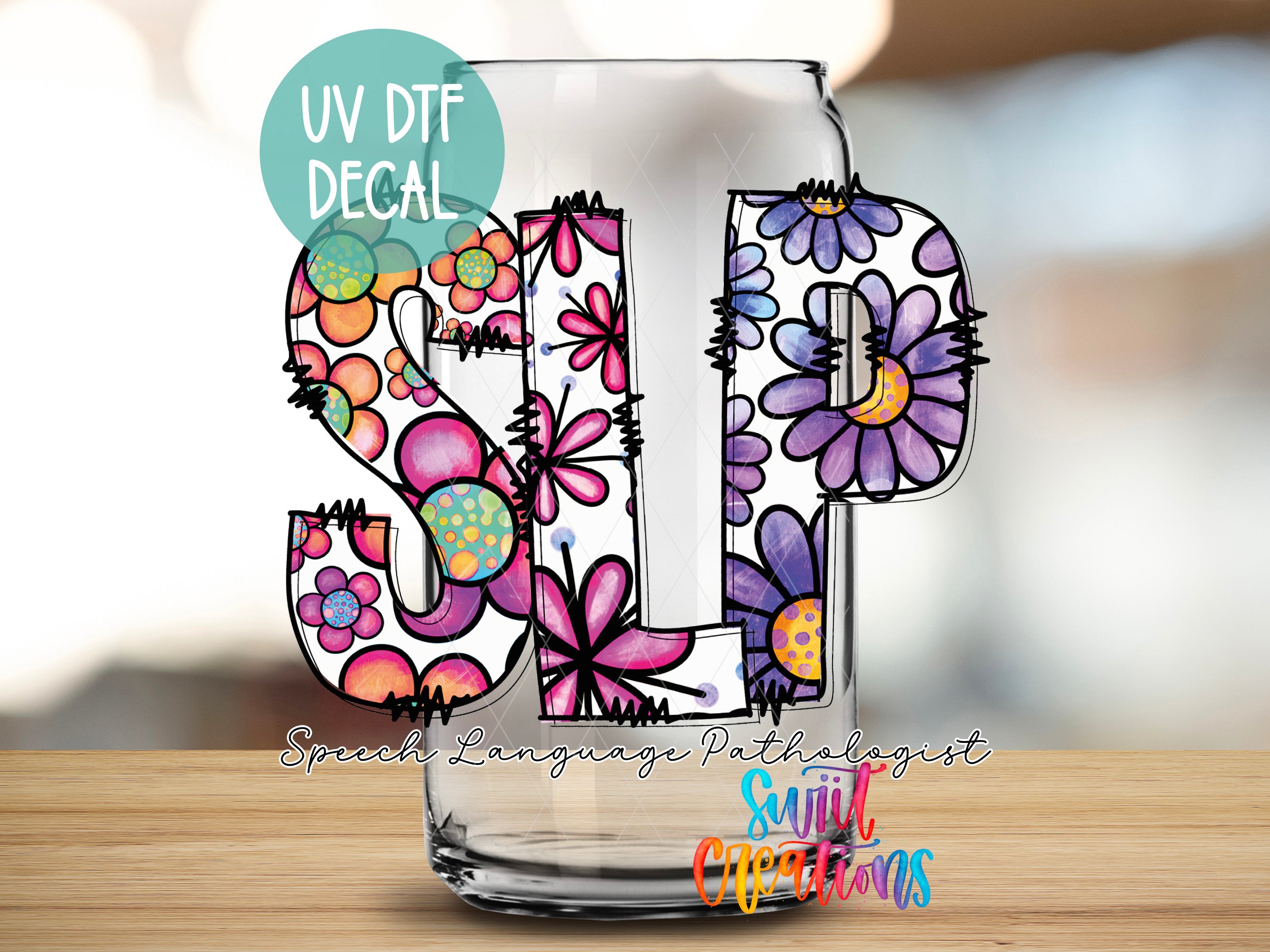 a glass with a floral design is displayed on a table