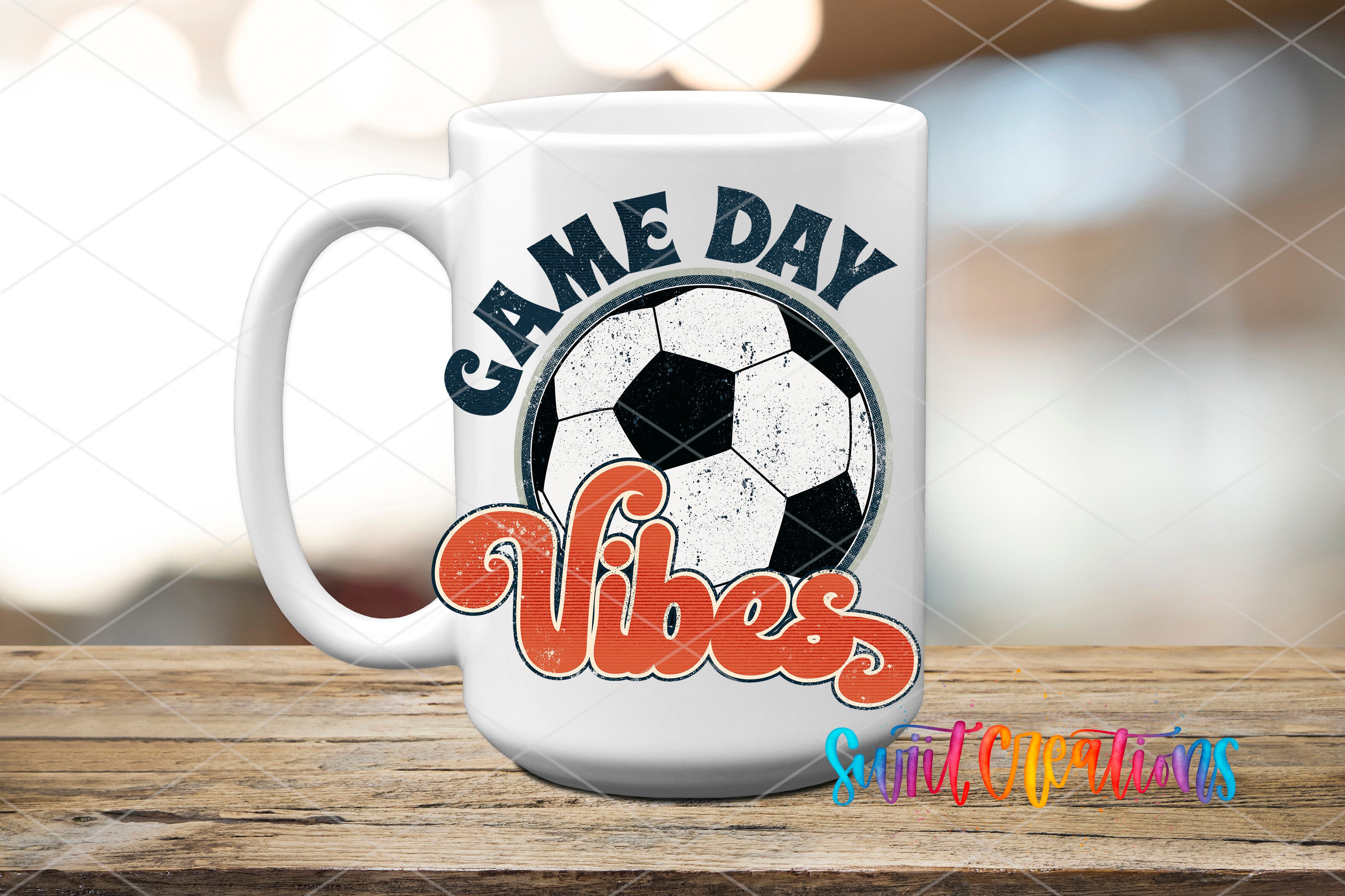 A white mug with a soccer ball design and the text "GAME DAY VIBES" printed on it, placed on a wooden surface.