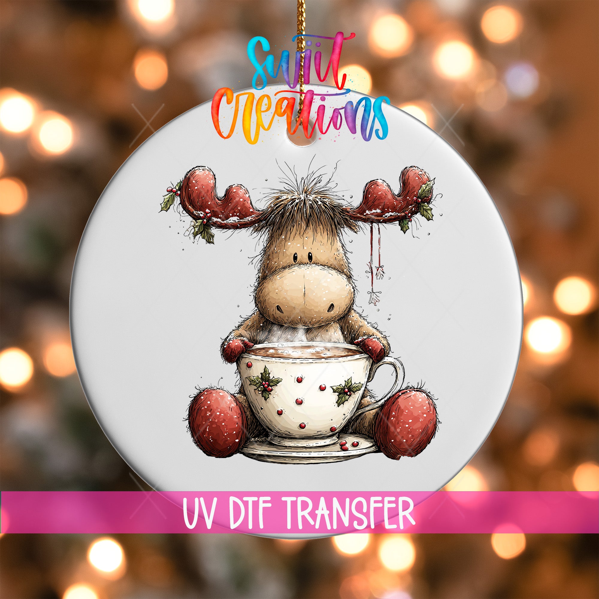 A white ornament with a cartoon moose holding a cup of hot chocolate, surrounded by festive holiday lights.