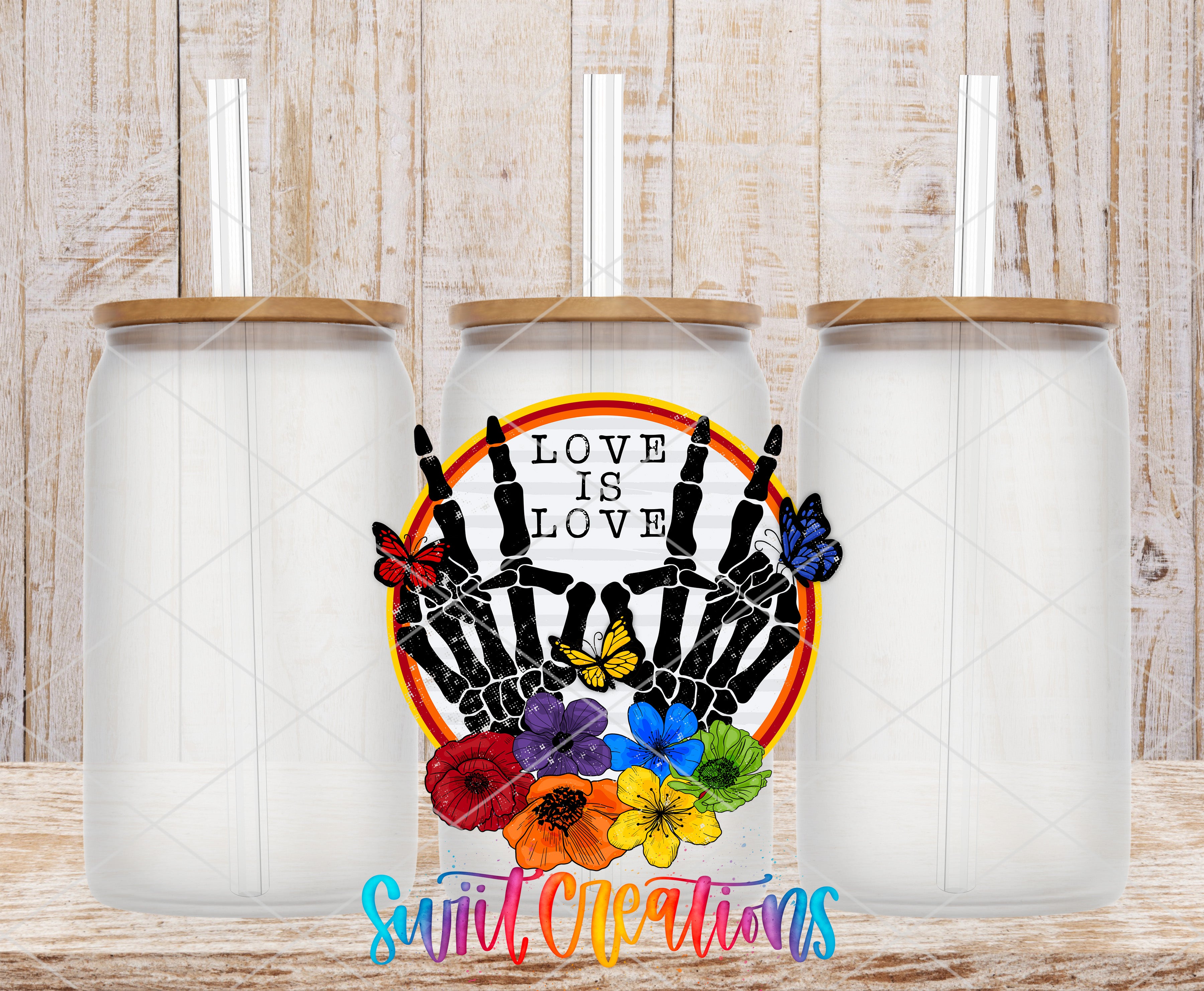 three glass jars with lids, each containing a straw. The jars are arranged in a row, and there is a colorful design on the center jar that includes a skeleton hand holding flowers and butterflies. The text "LOVE IS LOVE" is displayed on the center jar, and the phrase "Sweet Creations" is written below the jars.