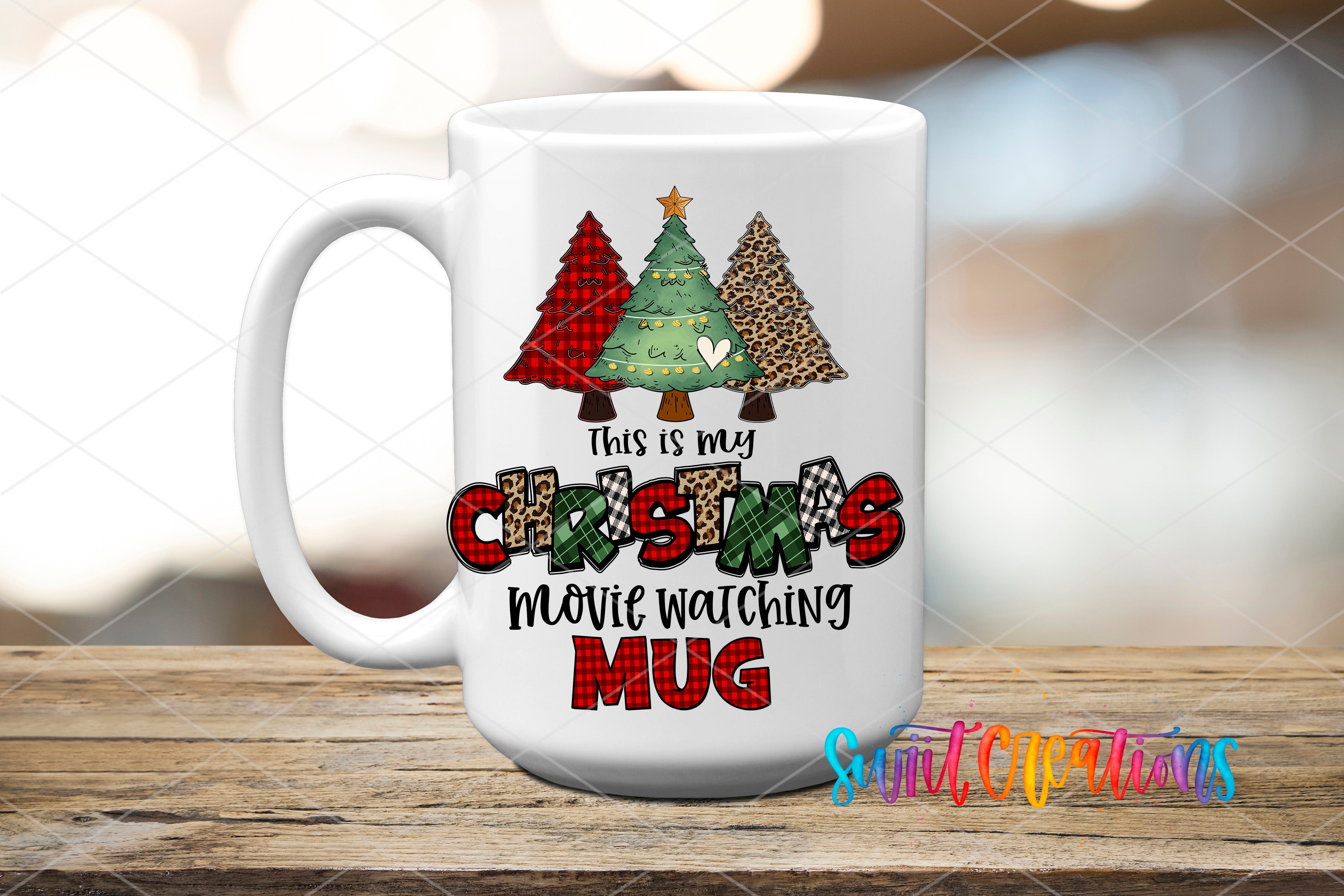 A white ceramic mug with a Christmas tree design and text that says "This is my Christmas movie watching mug"