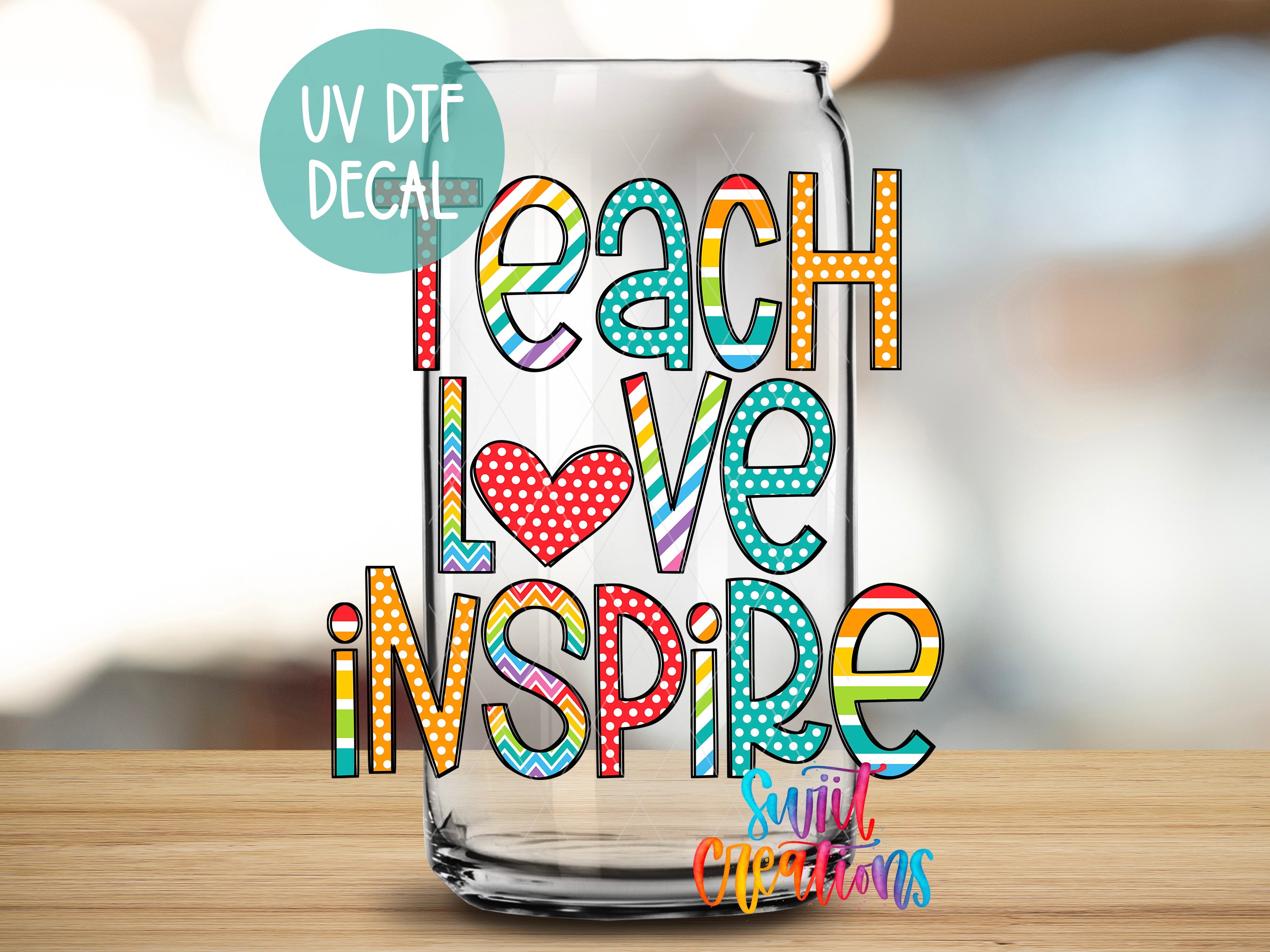 a glass with the words teach love inspire on it