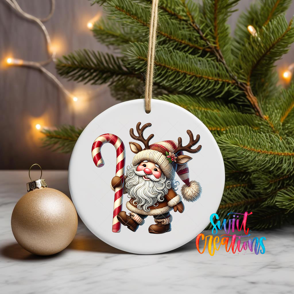 A white ornament featuring a cartoon Santa Claus holding a candy cane, surrounded by Christmas lights and greenery.