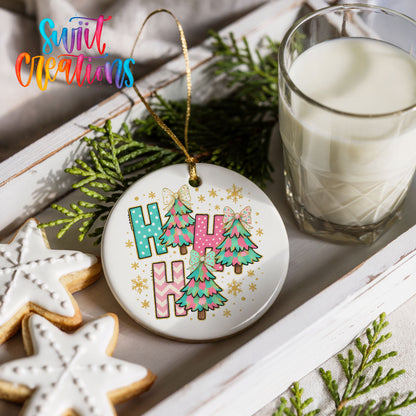 A festive Christmas scene with a white ornament featuring colorful Christmas trees, a glass of milk, and two star-shaped cookies on a white tray.