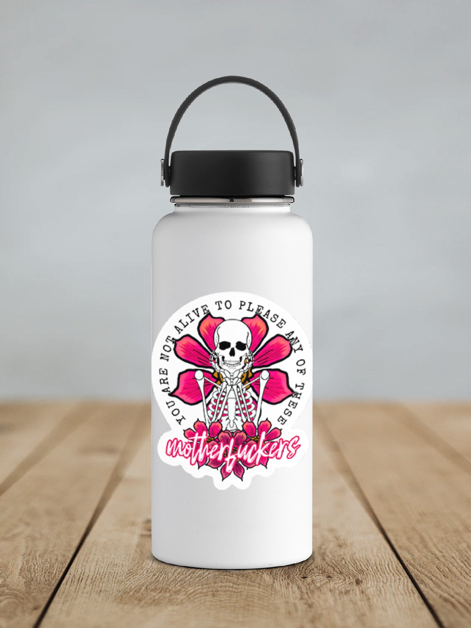 a white water bottle with a black lid on a wooden table