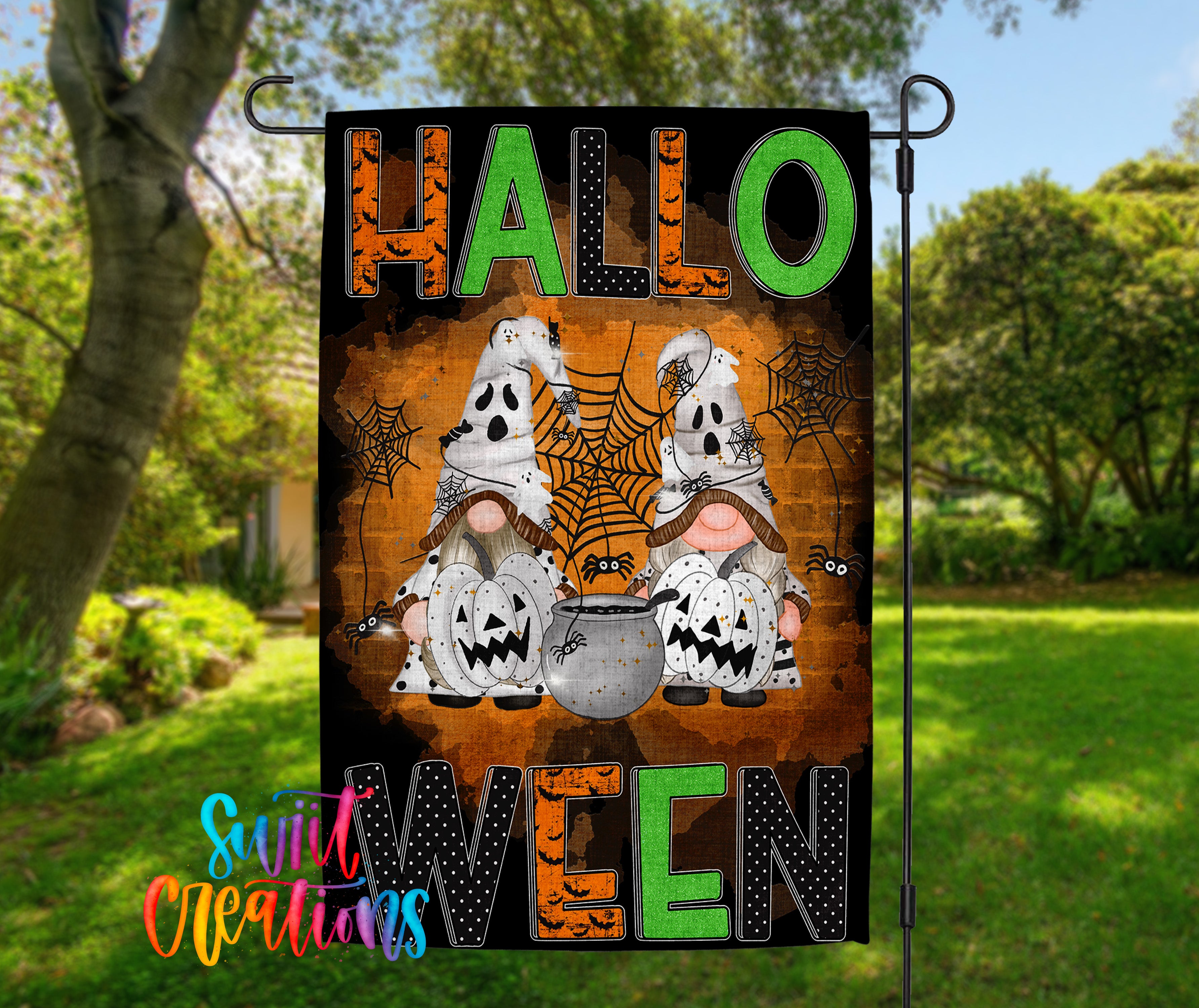 A Halloween-themed garden flag with the text "HALLO WELCOME" displayed prominently. The flag features illustrations of two gnomes, one wearing a ghost costume and the other a witch's hat, along with a spider web and pumpkins.