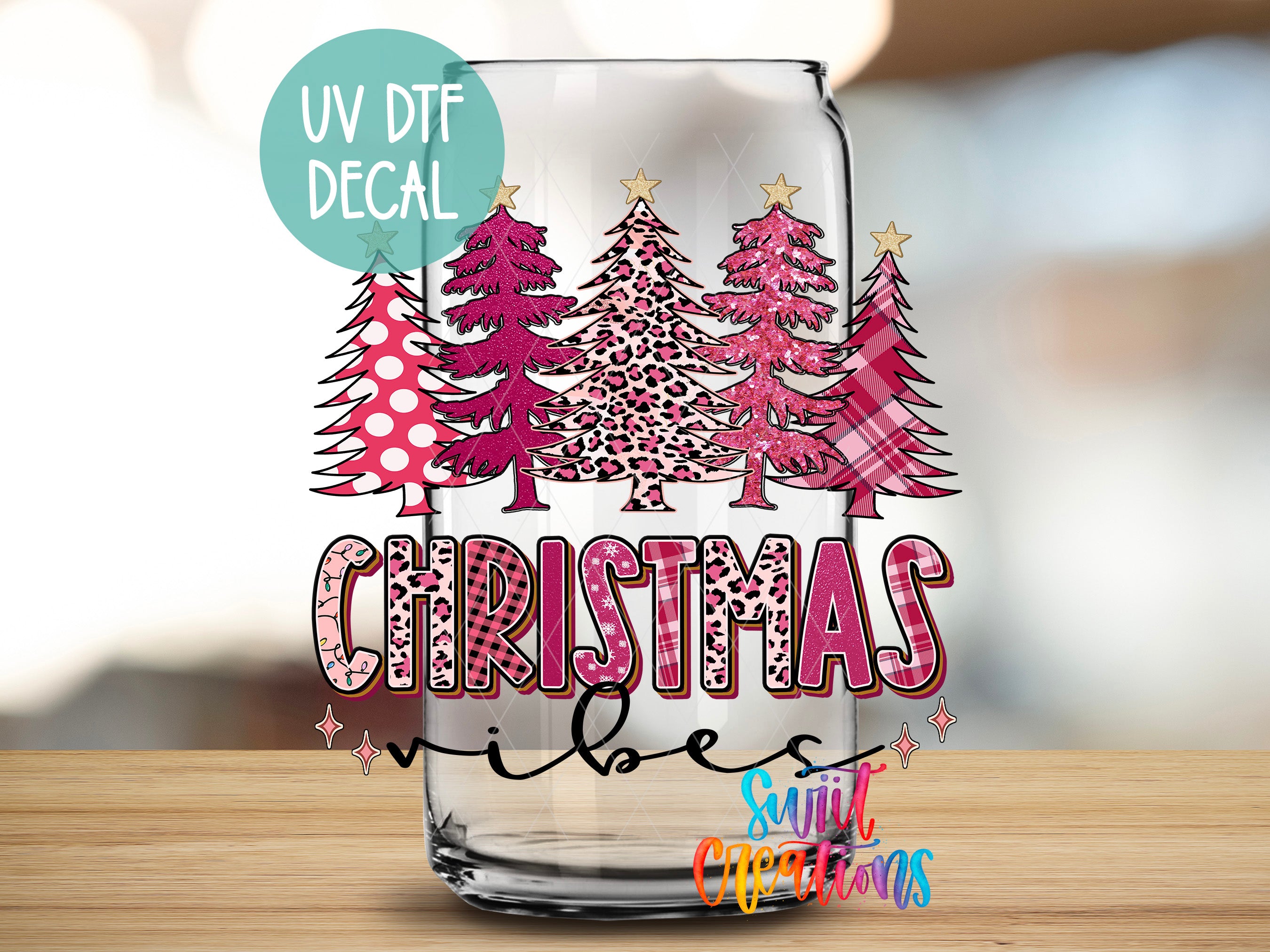 A glass with a Christmas tree decal on it, along with the text "Christmas vibes" and "Sunlit Christmas" written on it.