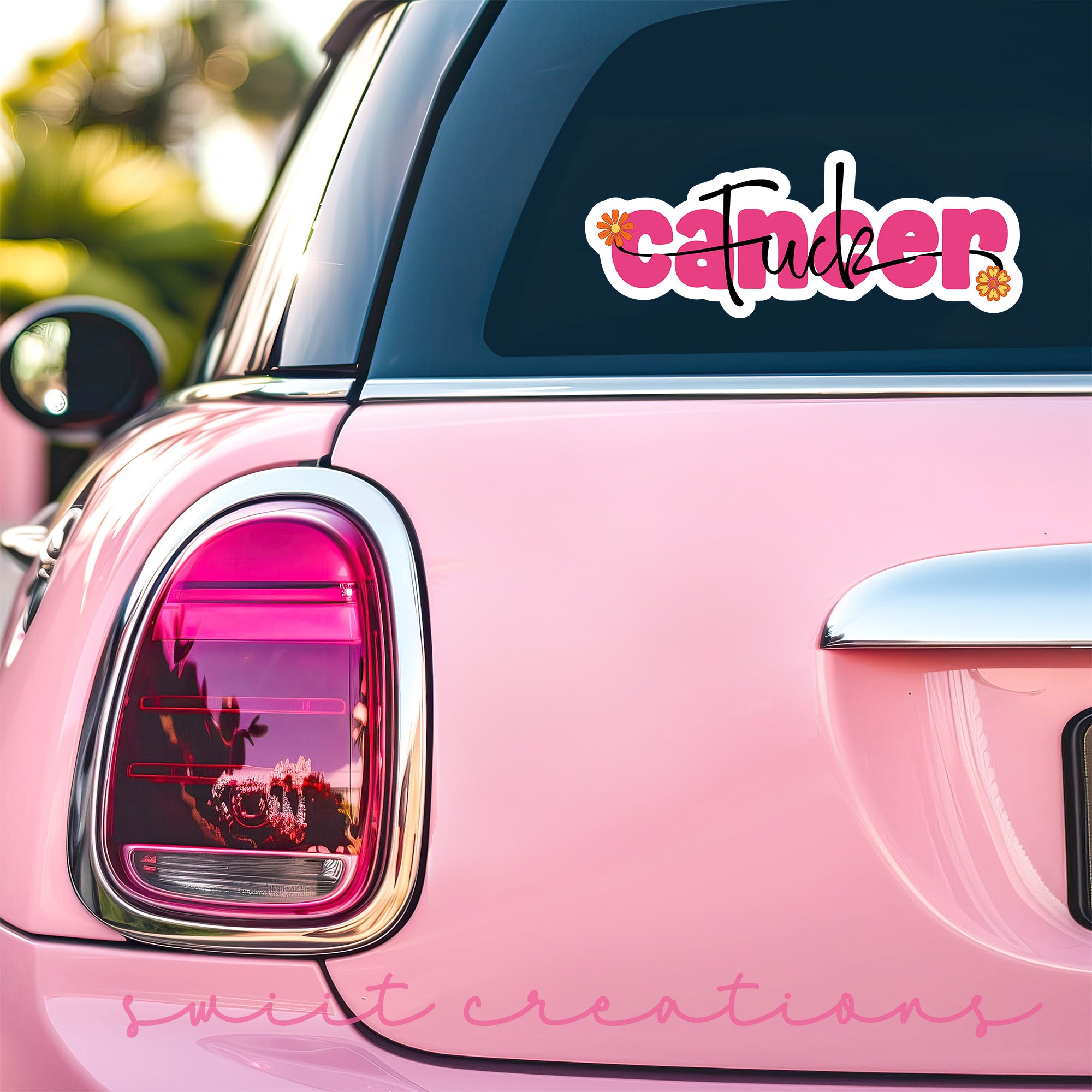 a pink car that has a sticker on it