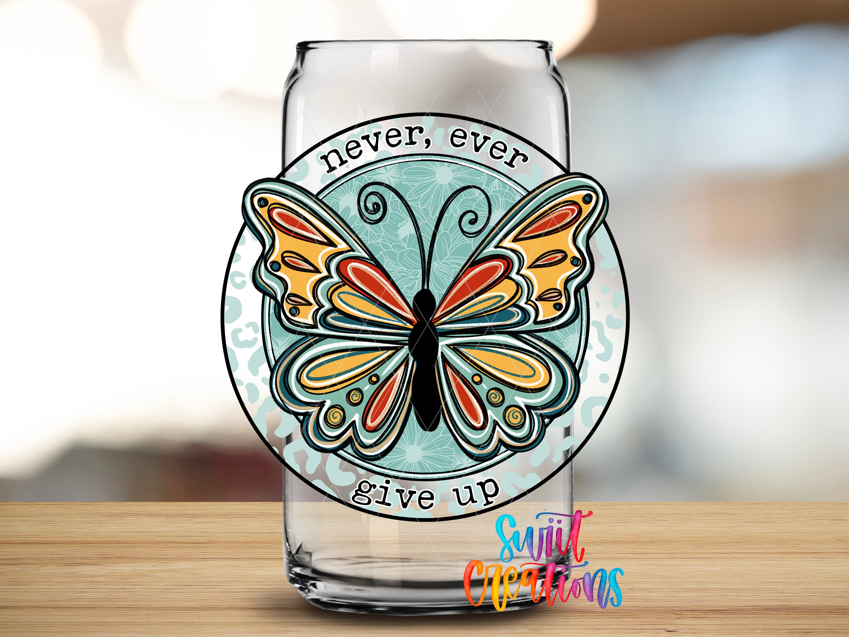 A glass can with a butterfly design and the text "Never, ever give up" printed on it.