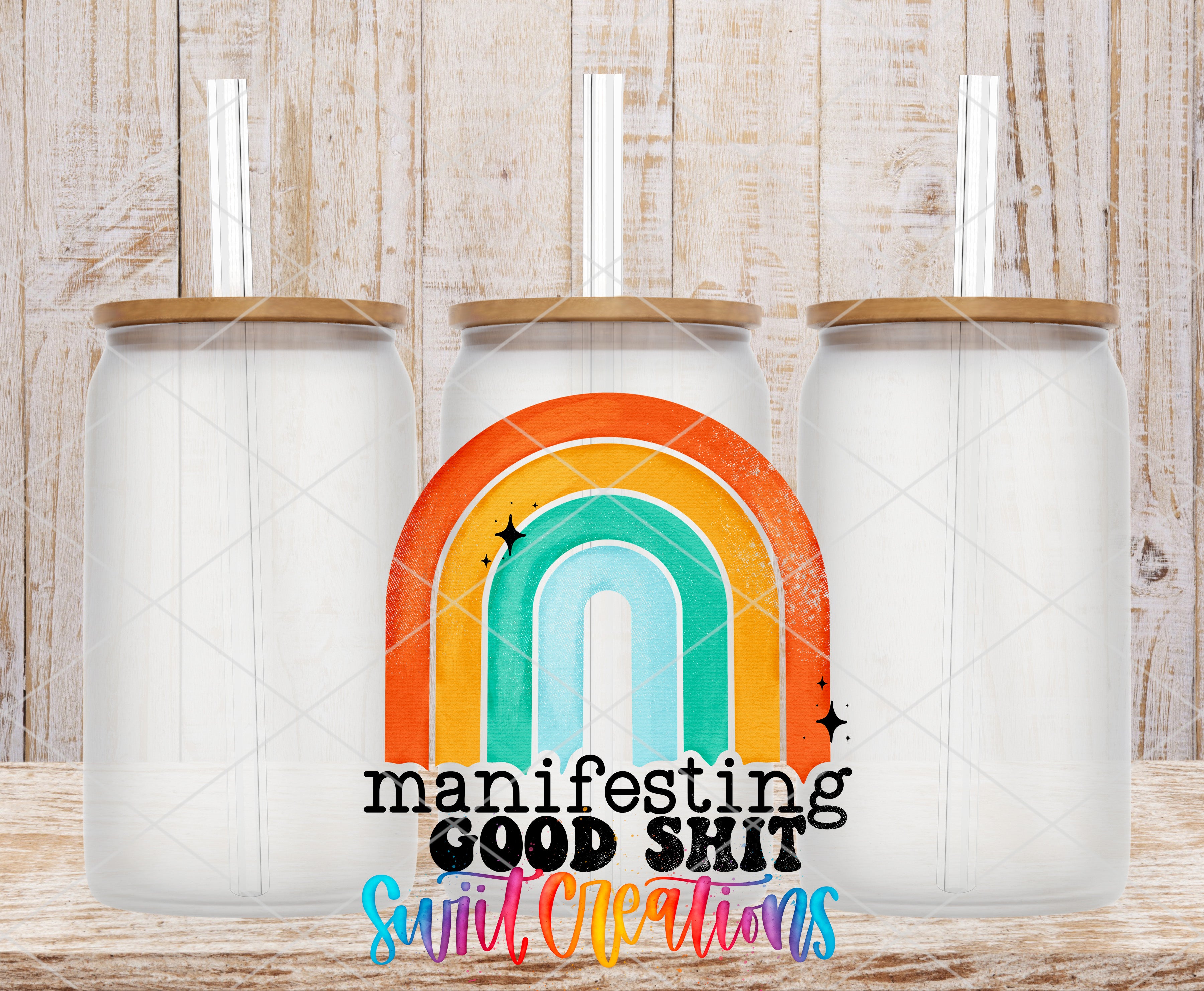 three glass jars with lids, arranged in a row against a wooden background. The jars have a colorful design on them, resembling a rainbow. The phrase "manifesting GOOD shit" is written in a stylized font in the center of the image.