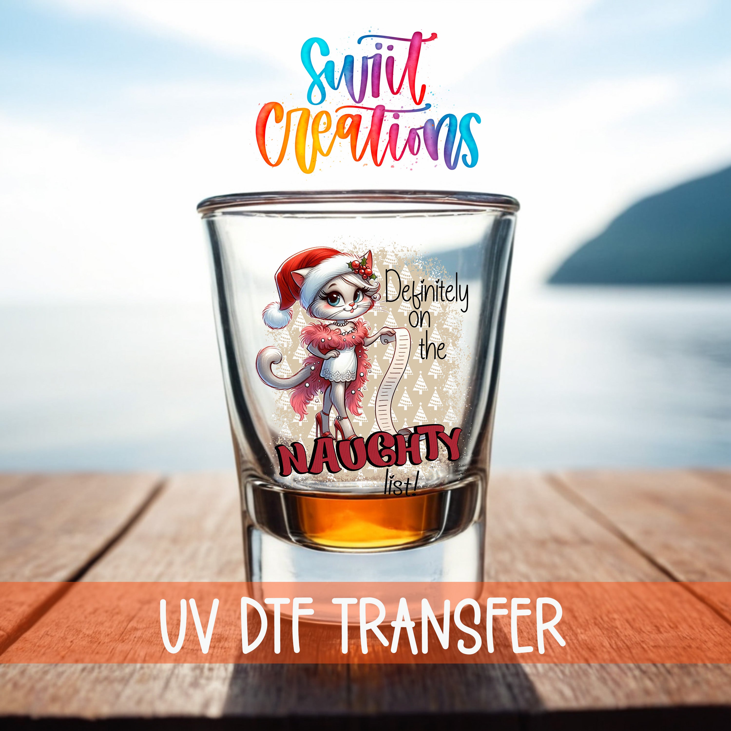 A shot glass with a cartoon character on it, placed on a wooden surface with a body of water in the background.