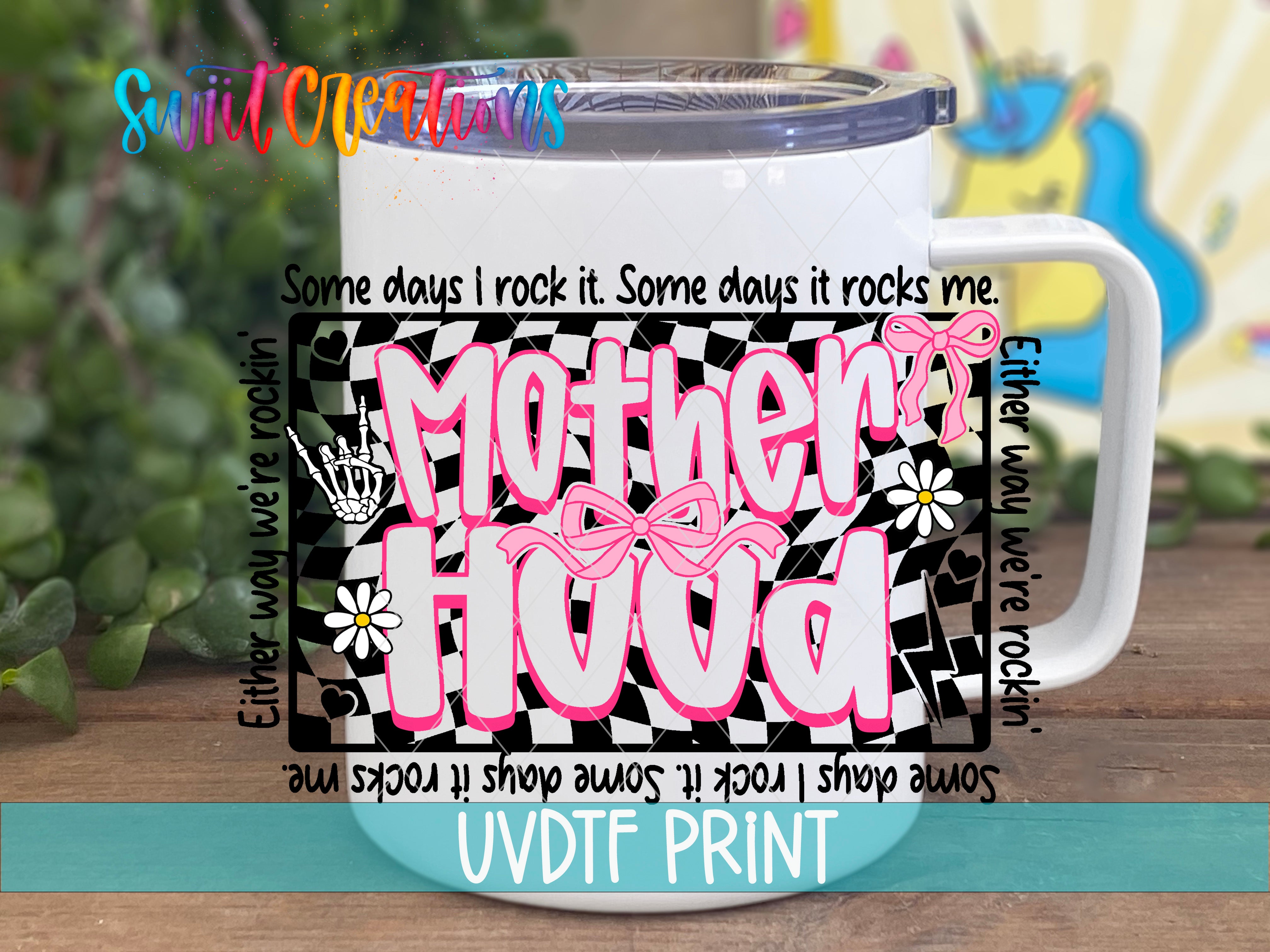A white mug with a colorful design and text printed on it, placed on a wooden surface.