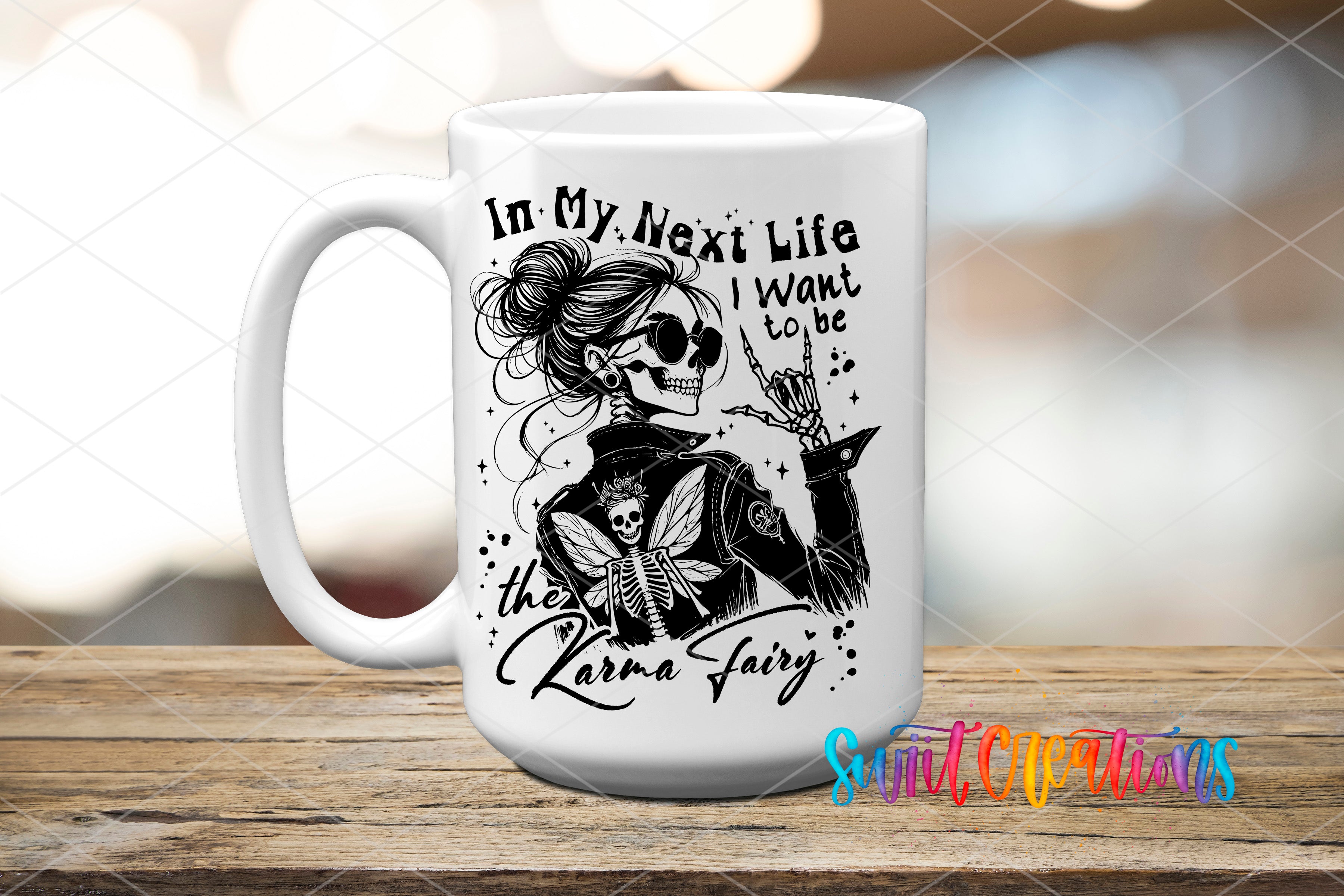 A white ceramic mug with a black and white illustration of a woman with a skull on her shoulder, along with the text "In My Next Life I Want to be the Karma Fairy".