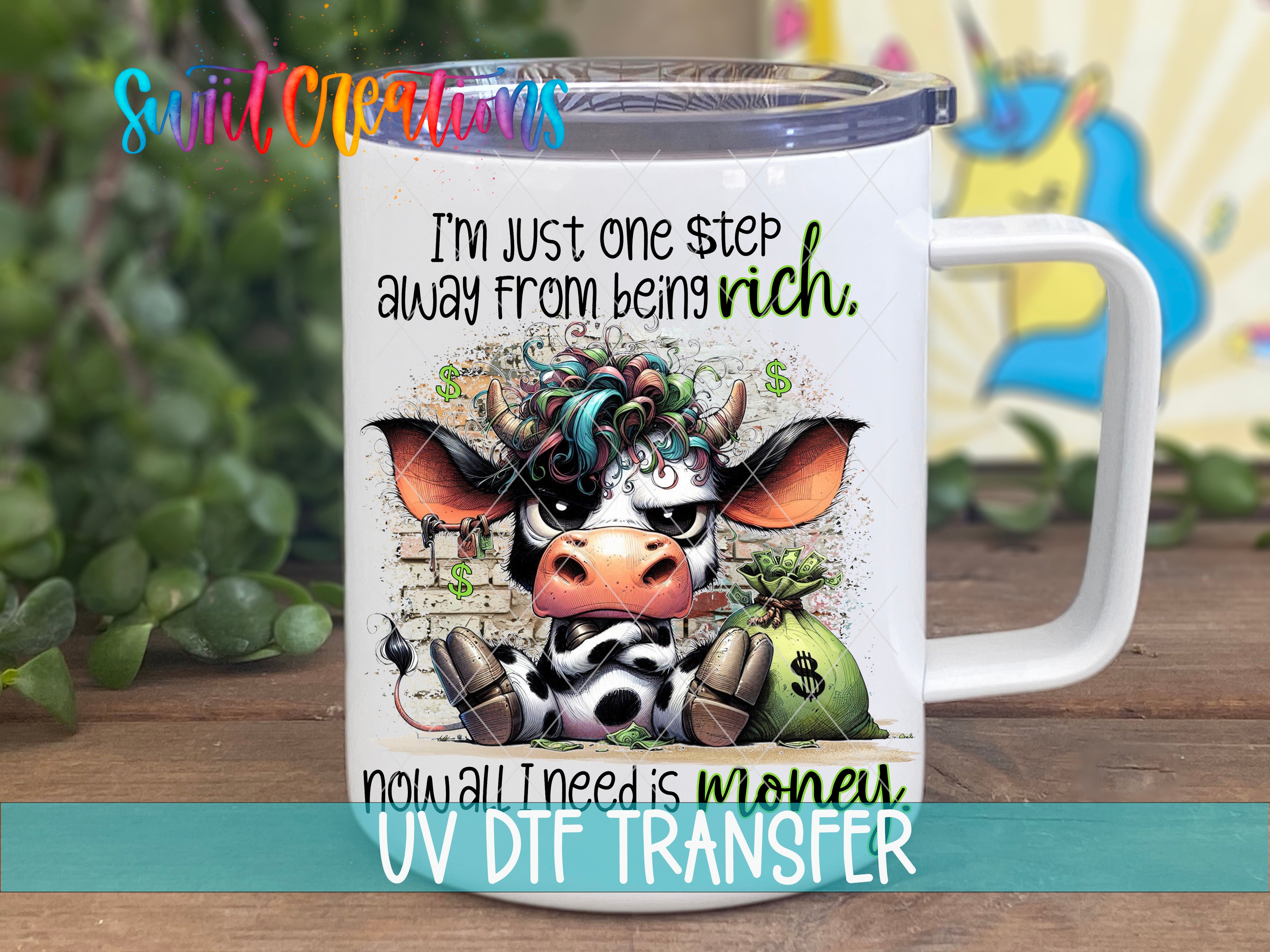 A mug with a cartoon cow and text on it, placed on a wooden surface.