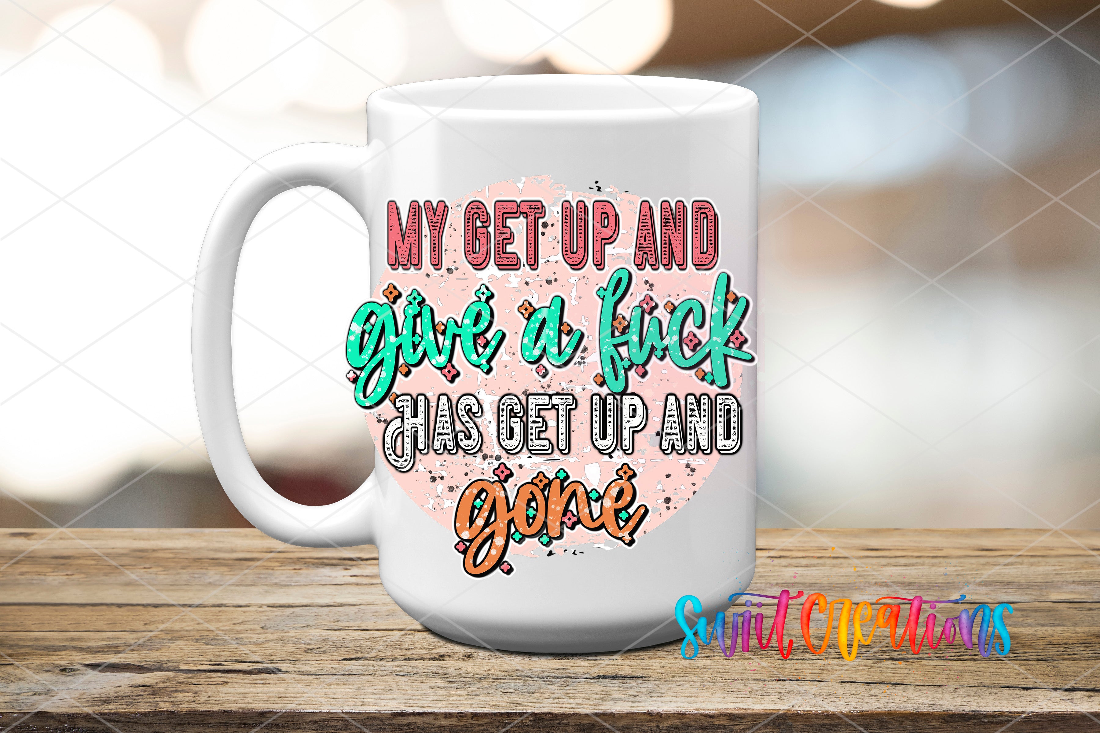 A white ceramic mug with colorful text and graphics printed on it, placed on a wooden surface.