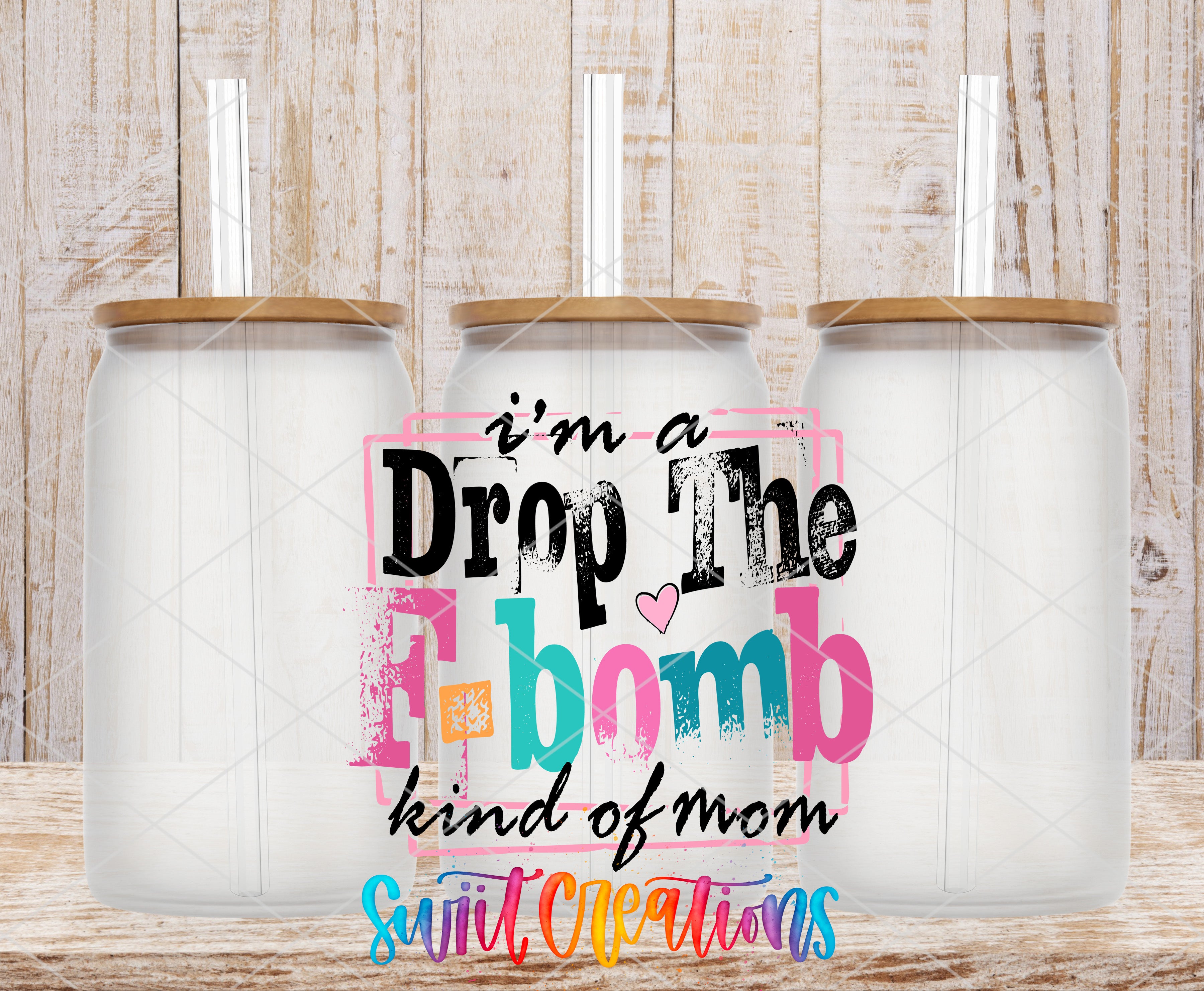three glass jars with lids, arranged in a row against a wooden background. The text overlay on the image reads "I'm a Drop The F-BOMB kind of mom" and "Suitable Creations".