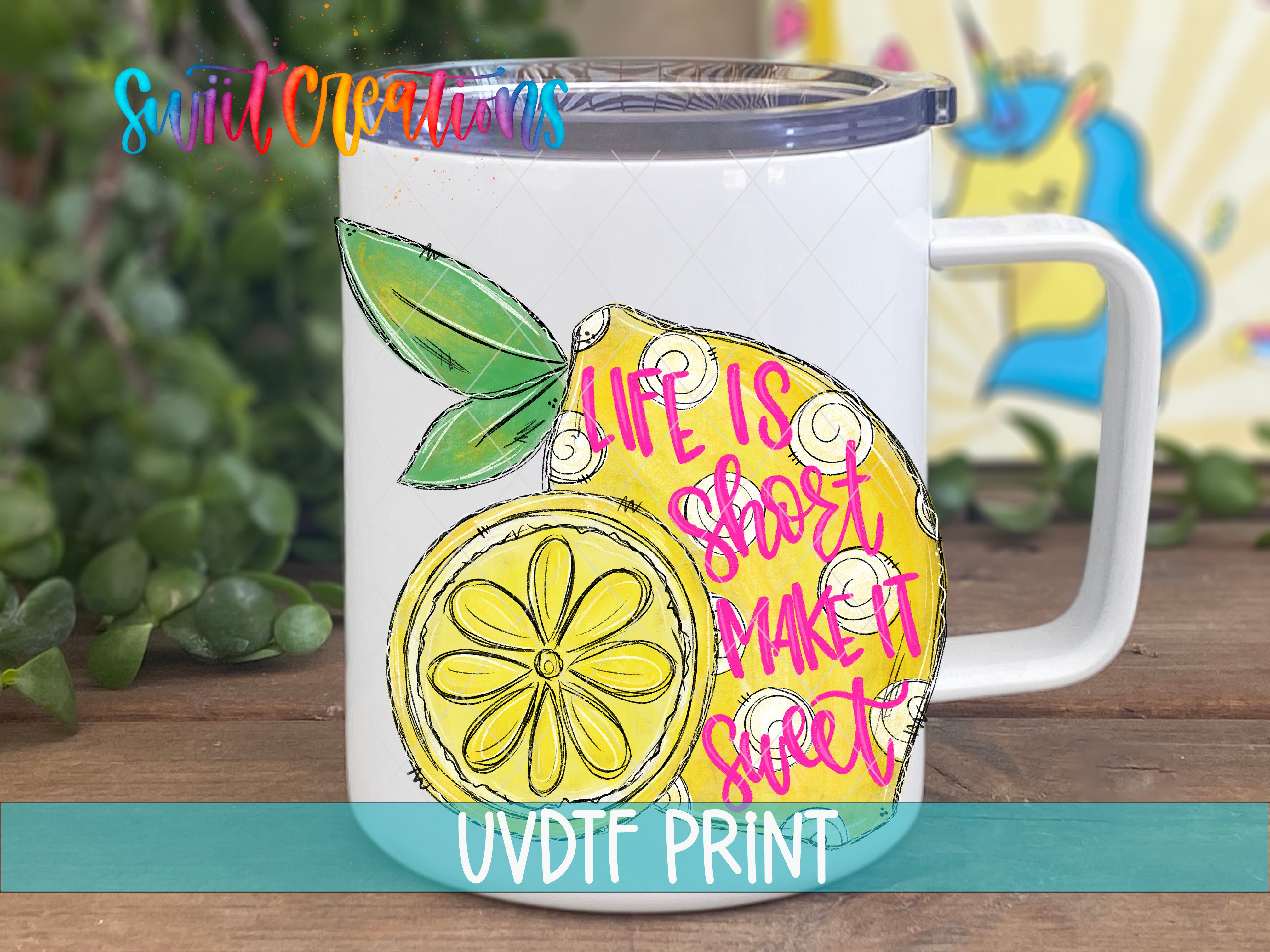 A white mug with a colorful illustration of a lemon and a flower on it, along with the text "Life is short, make it sweet" written on it.