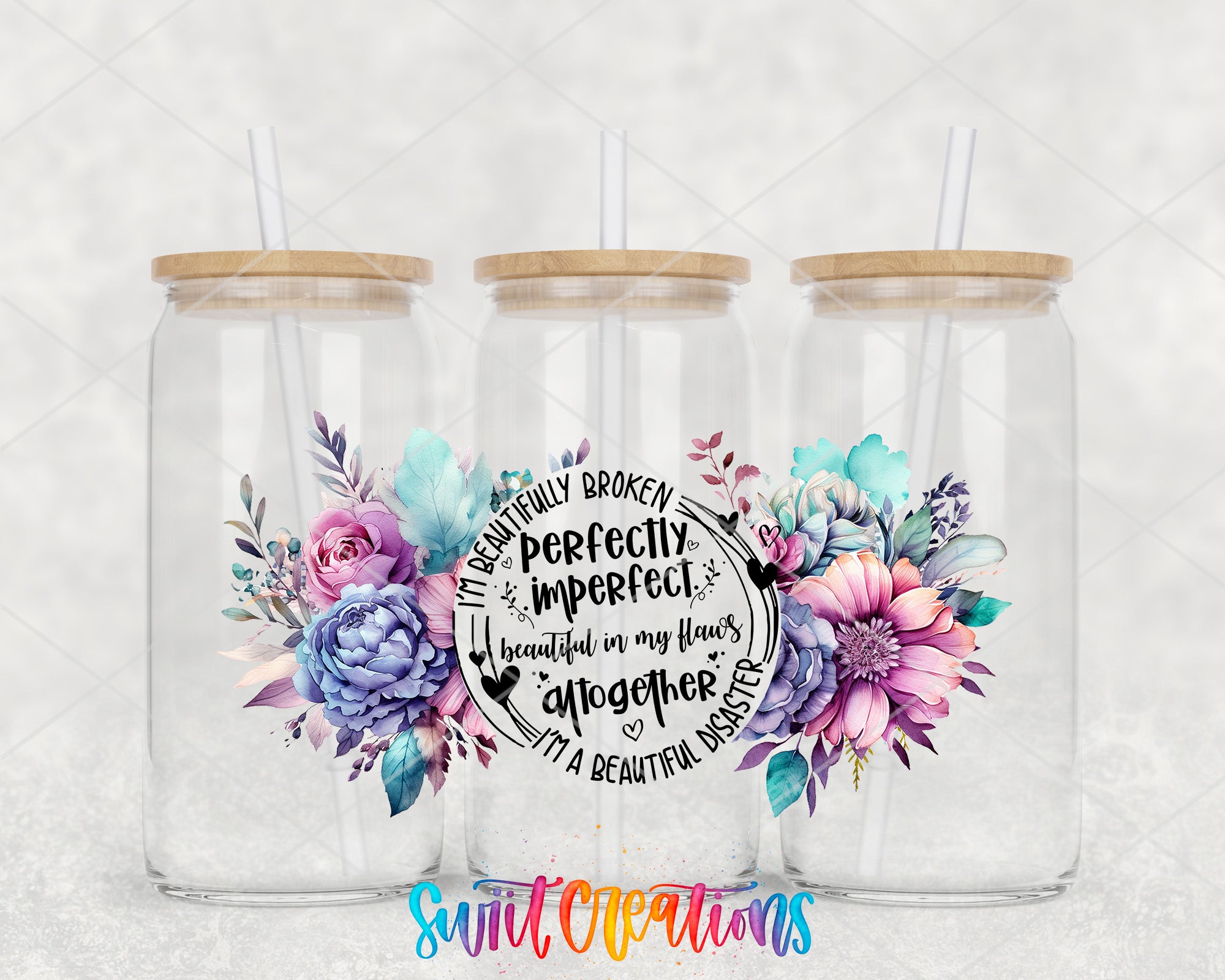 three glass jars with wooden lids, each containing a straw. The jars are adorned with colorful floral designs. The text "I'm beautifully broken perfectly imperfectly beautiful in my flaws together I'm a beautiful disaster" is displayed in the center of the image, surrounded by the floral designs.