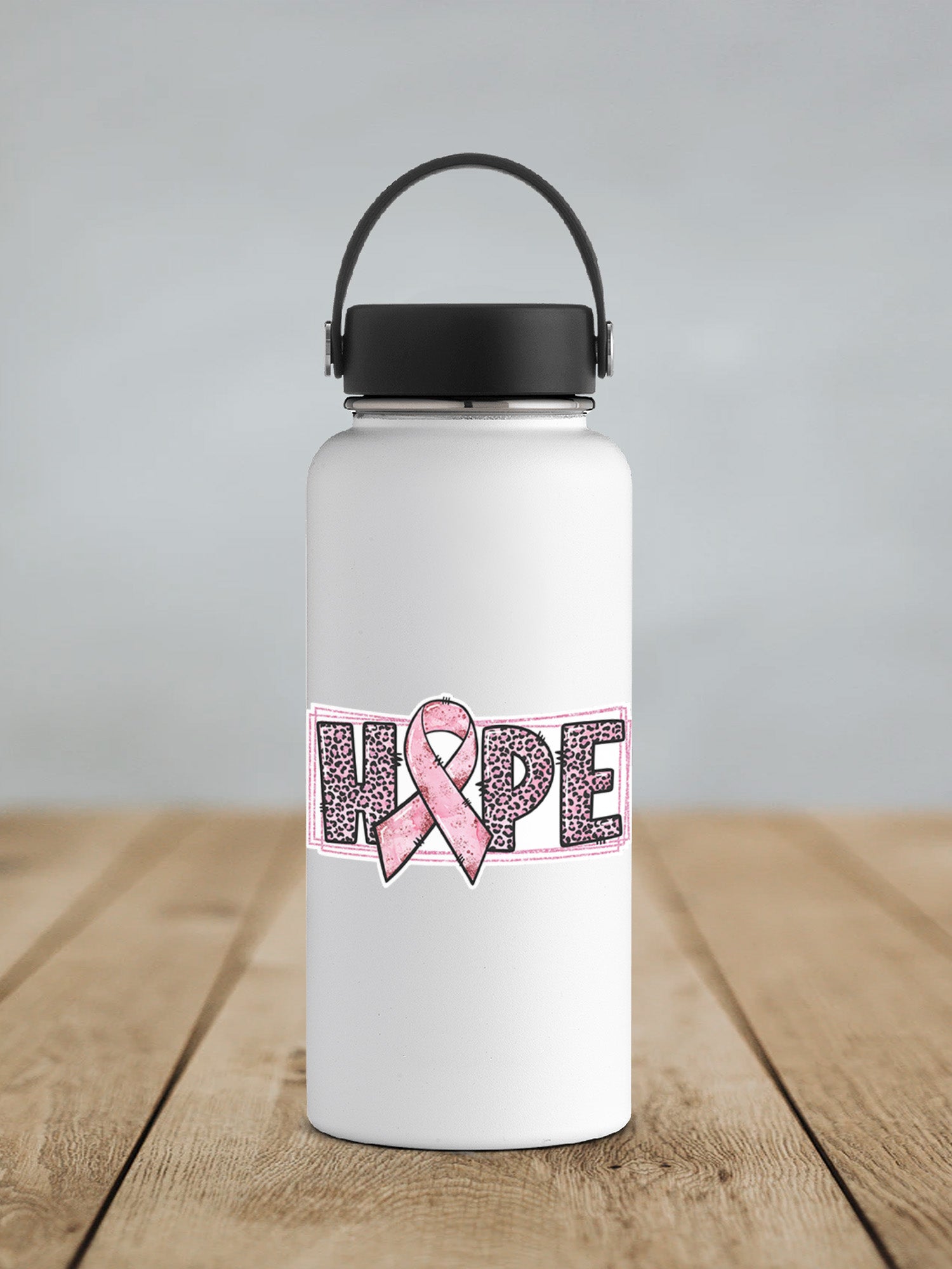 a white water bottle with a pink ribbon on it