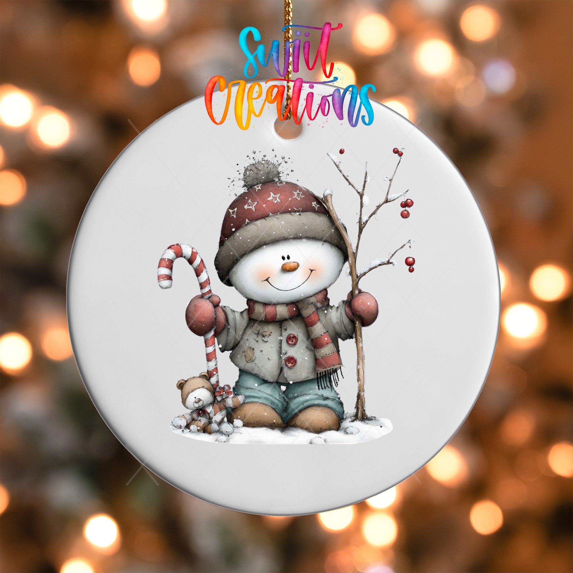 A snowman ornament with a candy cane and a teddy bear, set against a blurred background of twinkling lights.