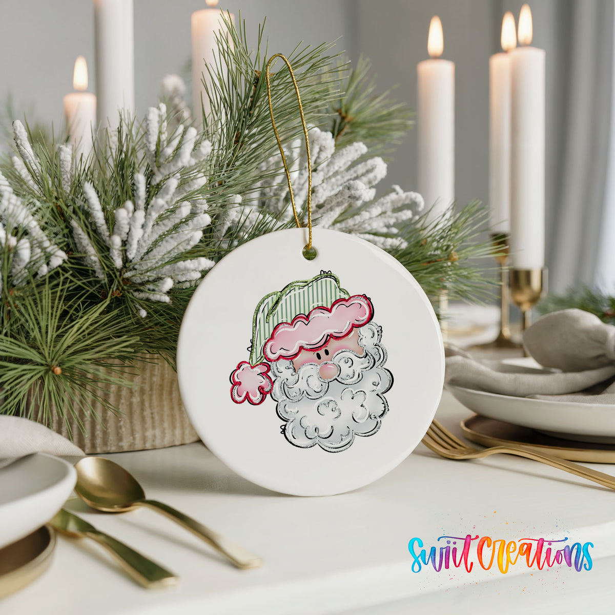 A white ceramic ornament with a Santa Claus face design is displayed on a table, surrounded by candles and greenery.