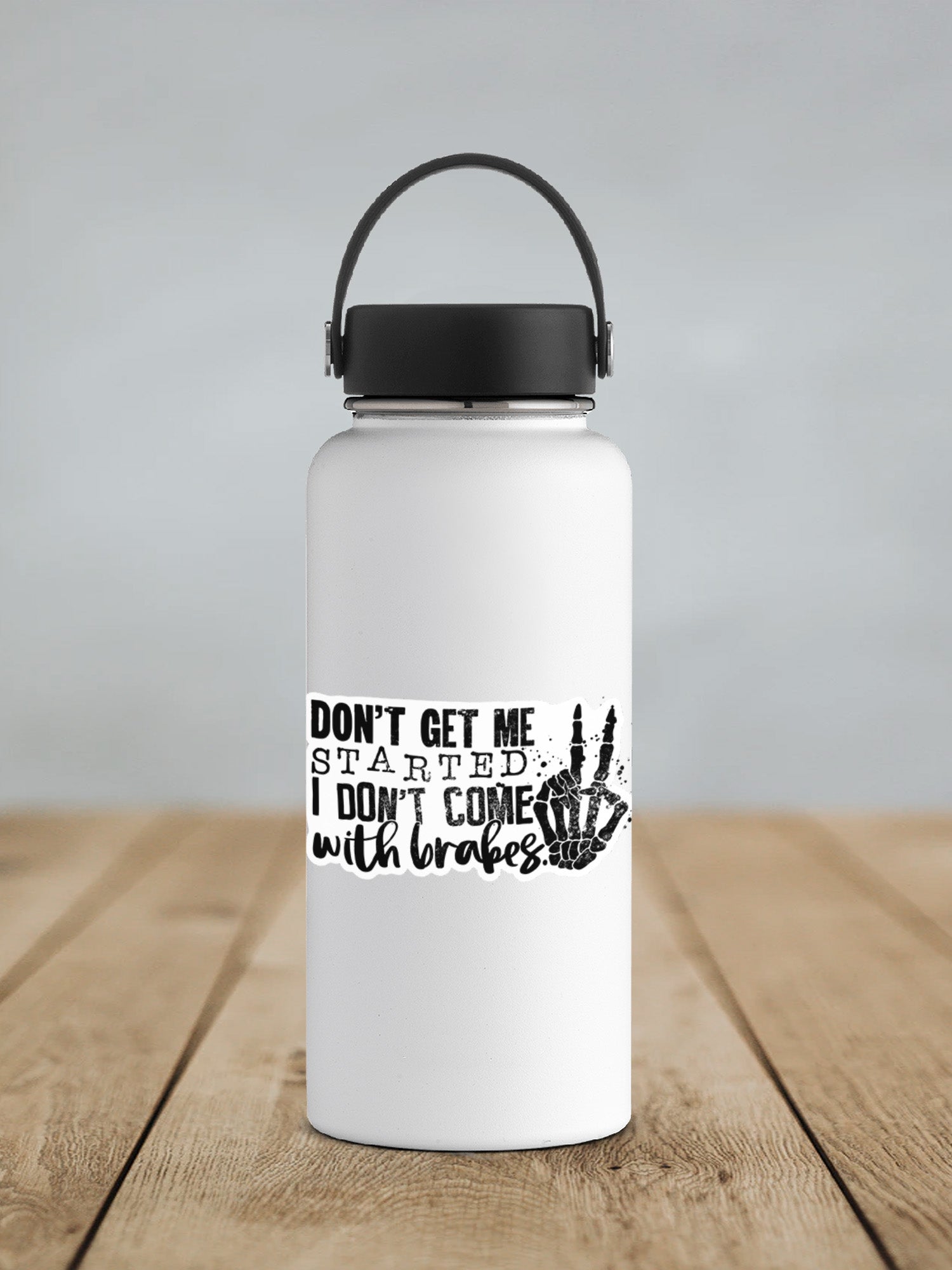 a white water bottle sitting on top of a wooden table