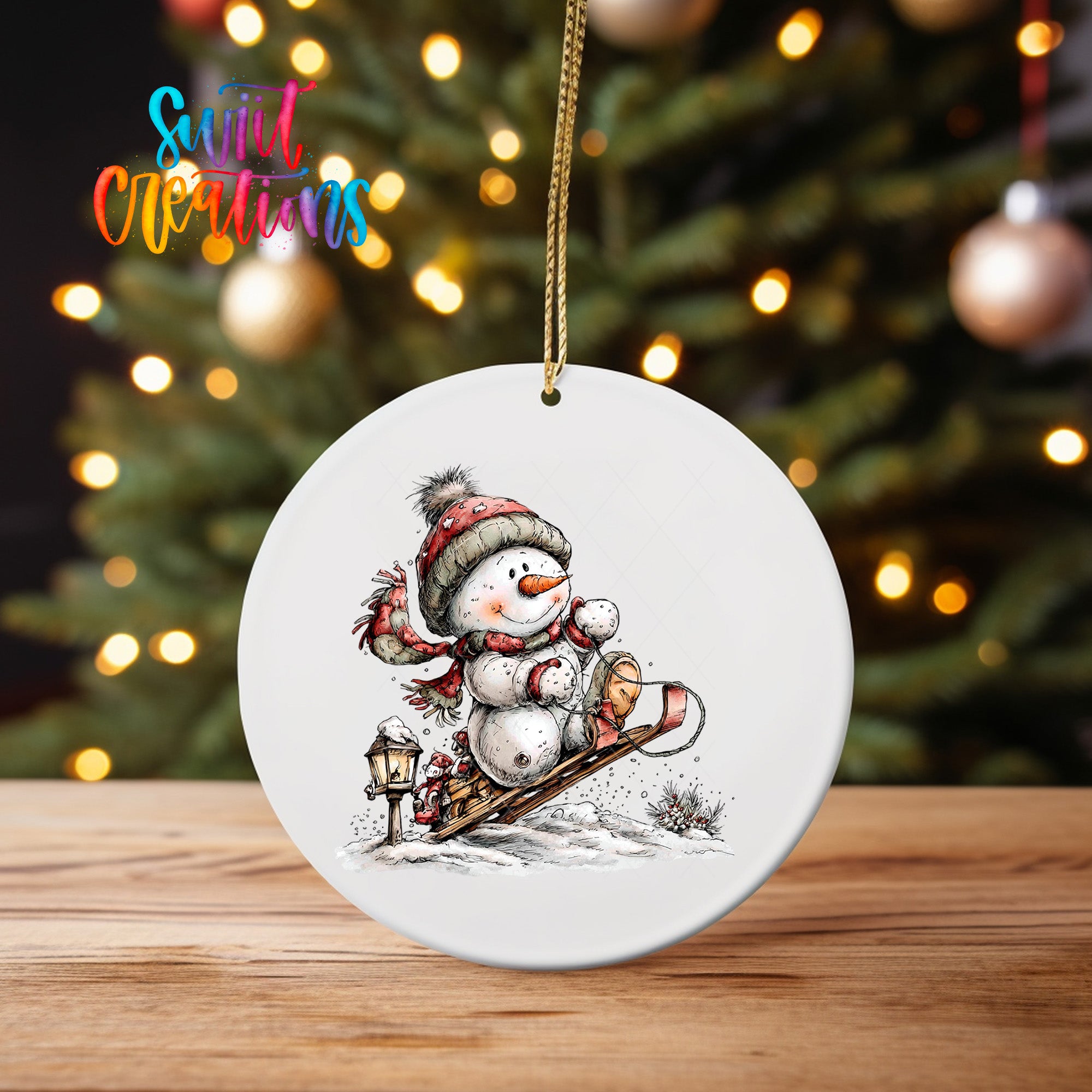 A white ceramic ornament featuring a snowman with a lantern, set against a blurred background of Christmas lights.