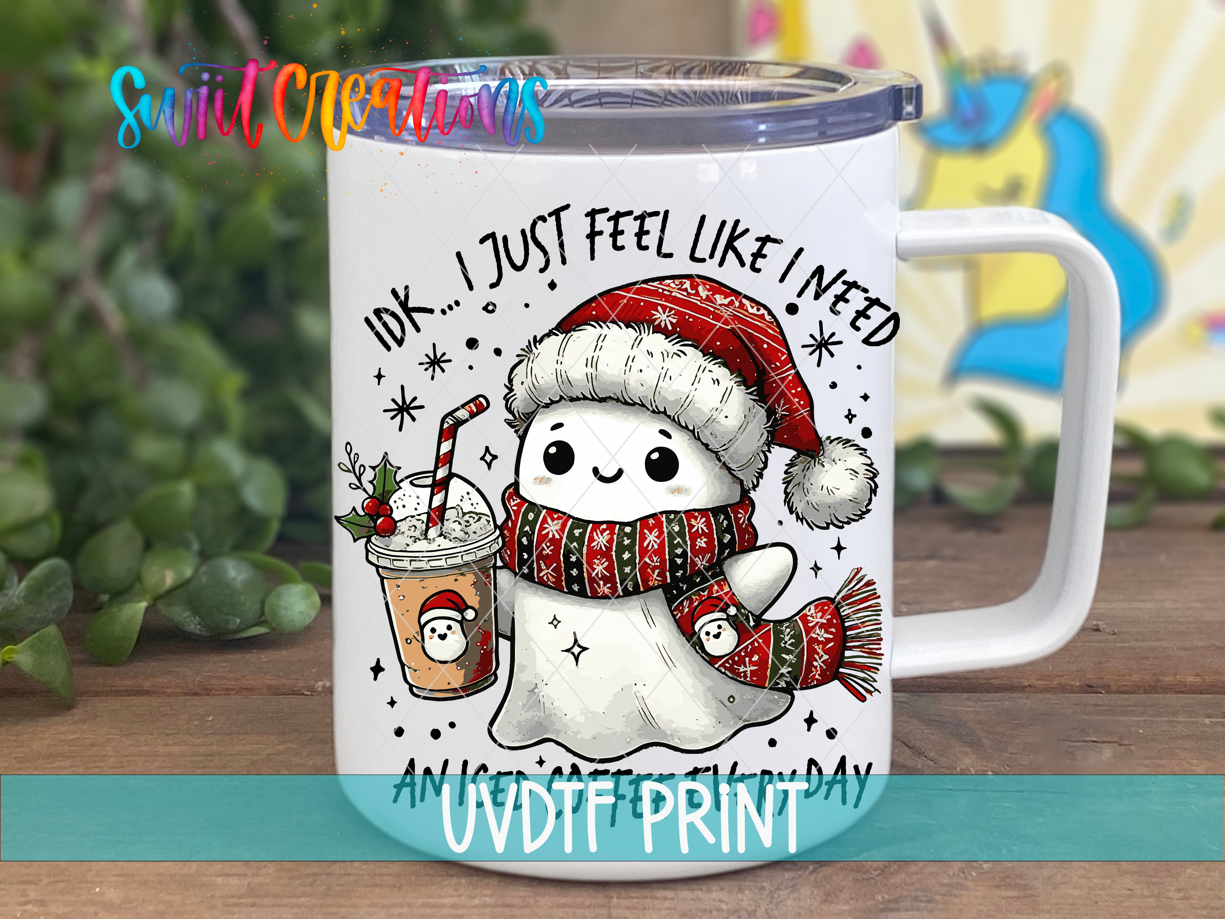 A mug with a cartoon ghost wearing a Santa hat and scarf, holding a drink and surrounded by snowflakes and stars.