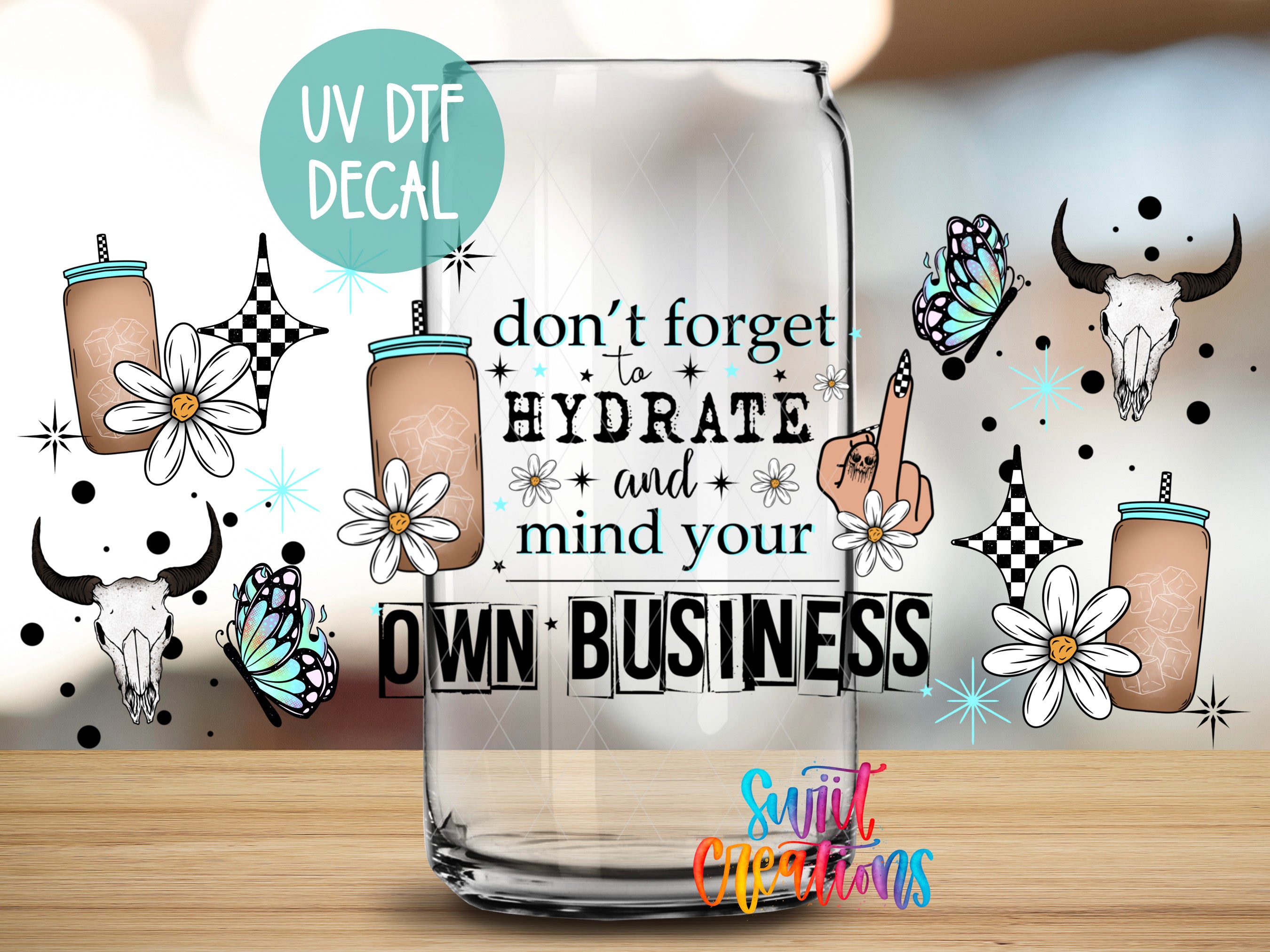 a glass with a picture of a cow and flowers on it