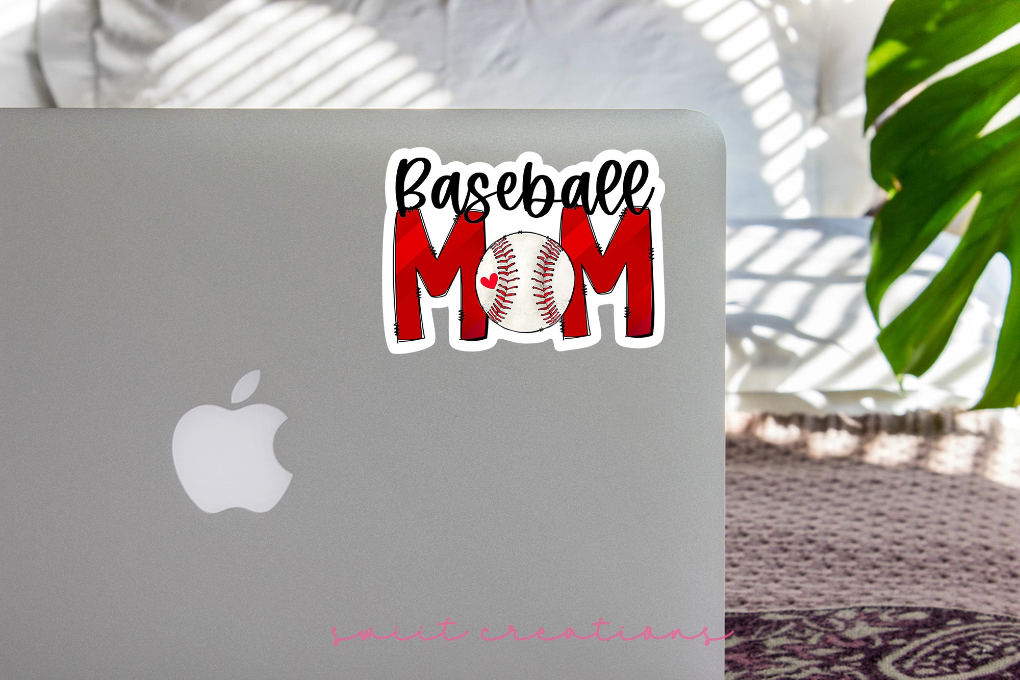 a laptop with a baseball mom sticker on it
