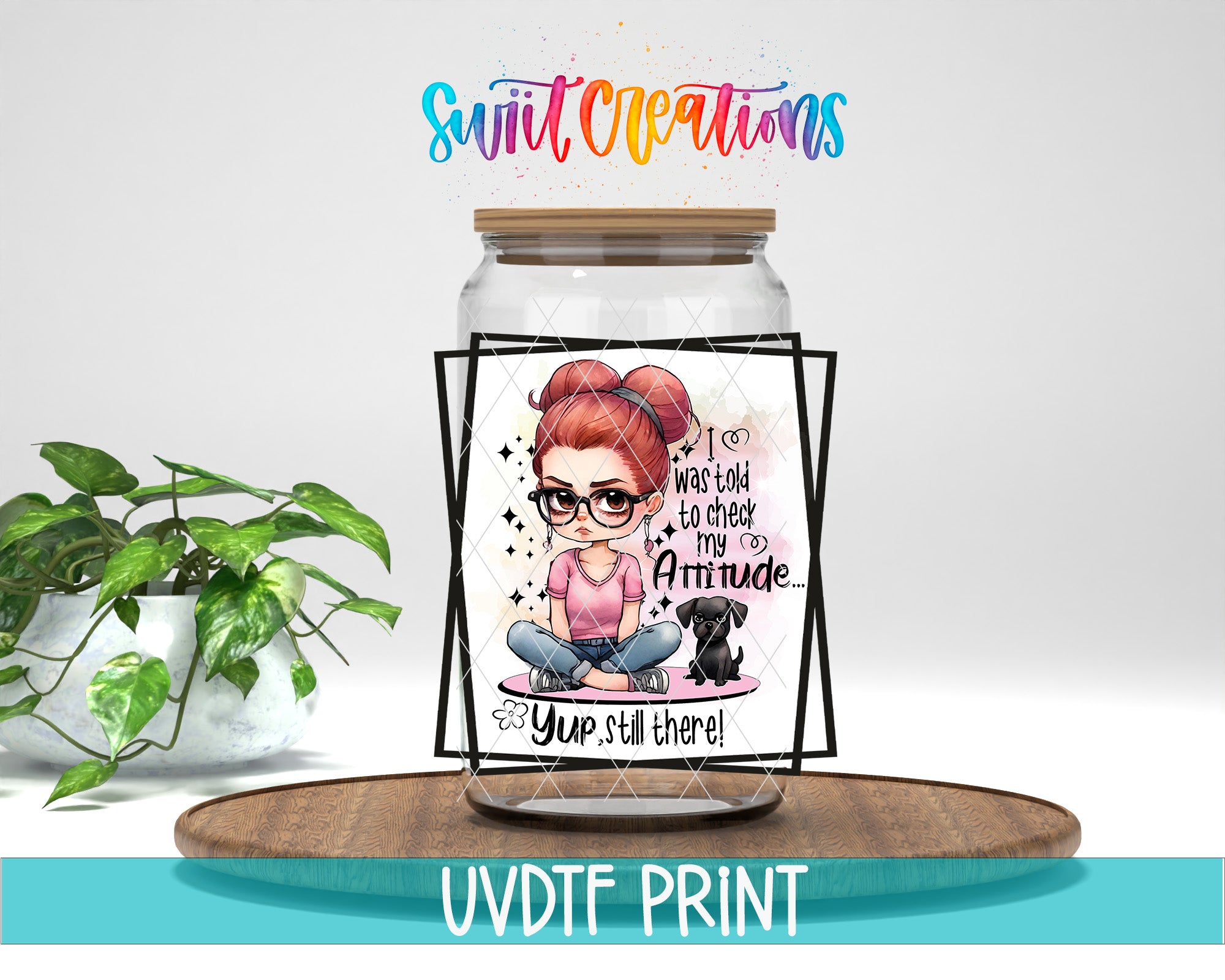a glass jar with a cartoon illustration of a woman sitting on a pink cushion, accompanied by a dog. The jar has a wooden lid and is placed on a wooden tray. The background of the image is white, and there is a plant visible in the background. The text "Swift Creations" is written above the jar, and "UVDDF PRINT" is written below it.