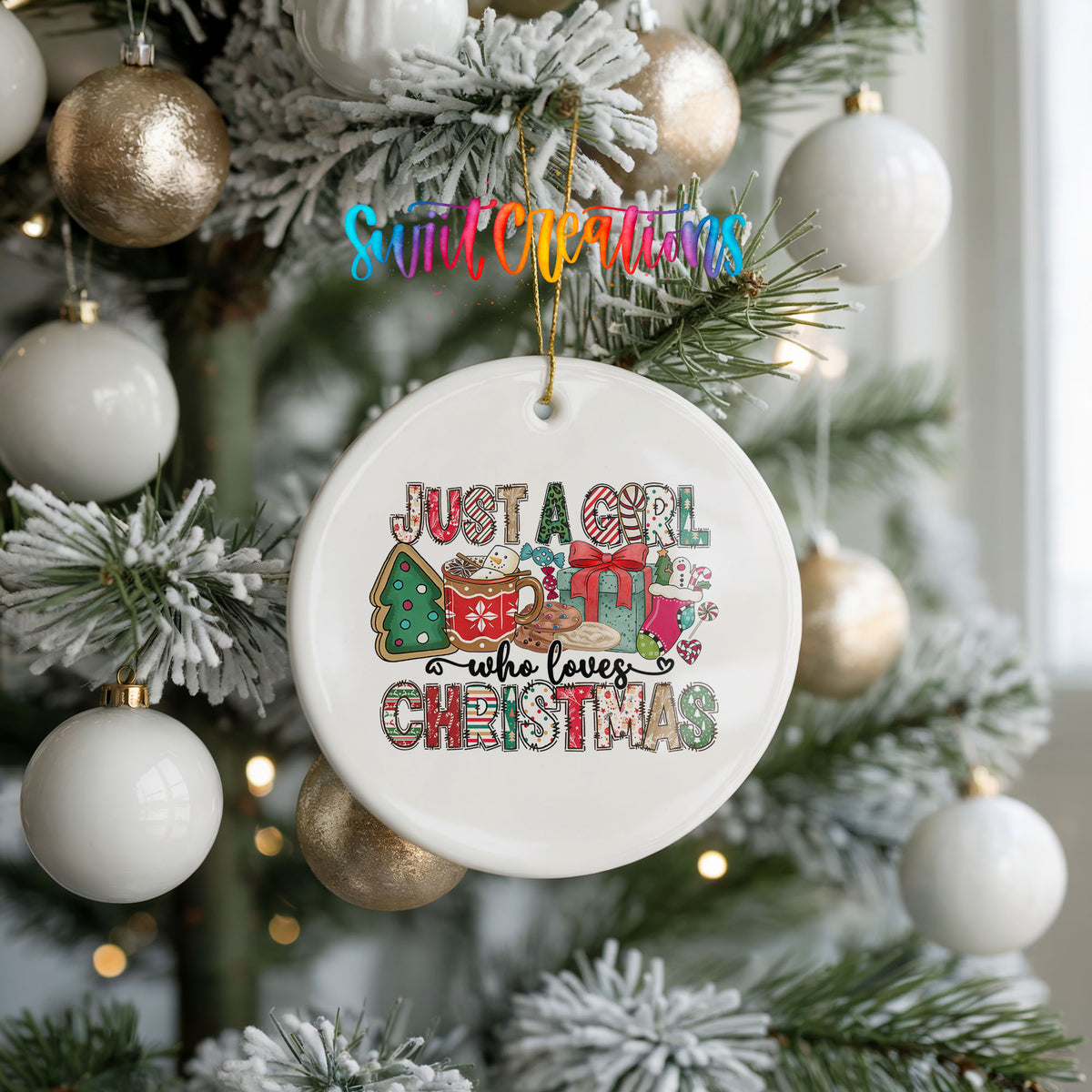 A white Christmas ornament with a colorful design hangs from a tree, surrounded by other ornaments.