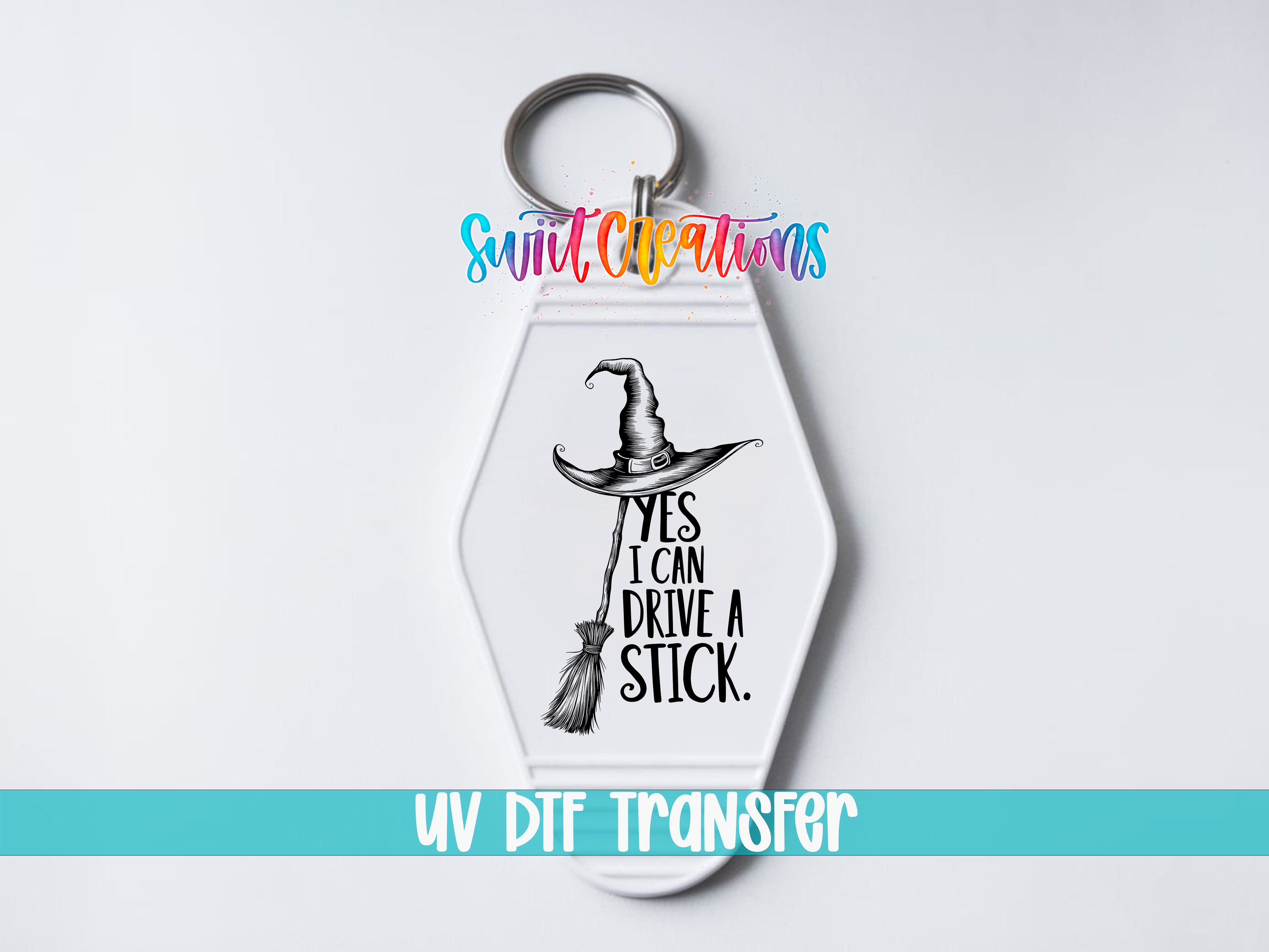 A keychain with a witch's hat and the text "YES I CAN DRIVE A STICK" printed on it.
