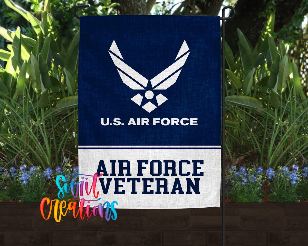 A blue flag with the U.S. Air Force logo and the text "AIR FORCE VETERAN" is displayed in front of a garden with green plants and flowers.