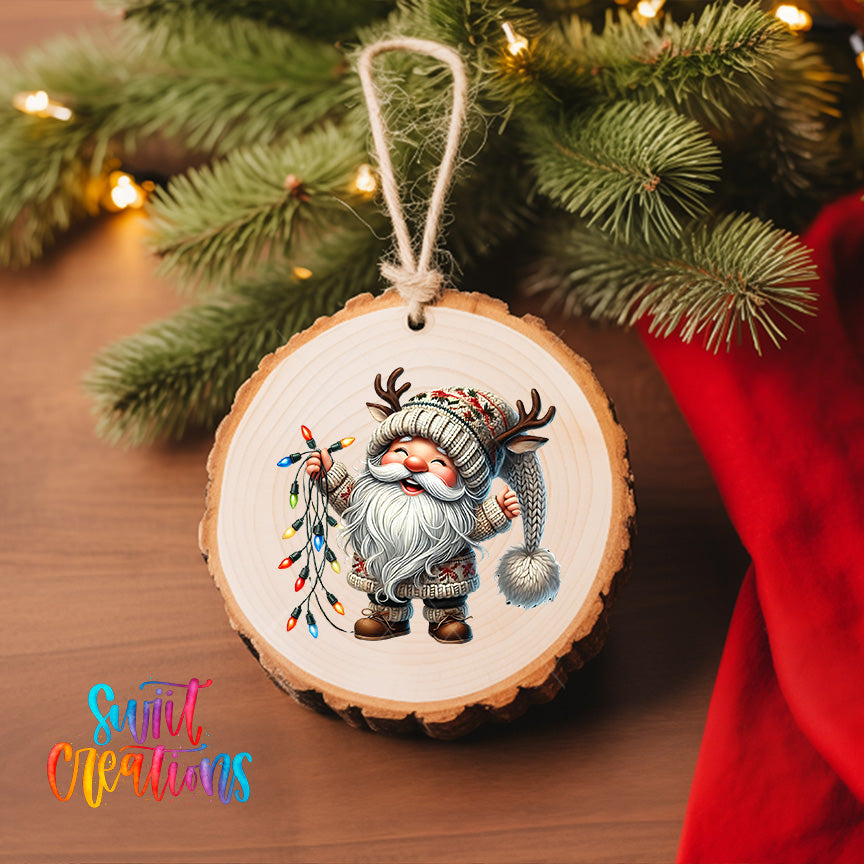 A wooden ornament featuring a smiling gnome holding a string of colorful lights, hanging on a Christmas tree.