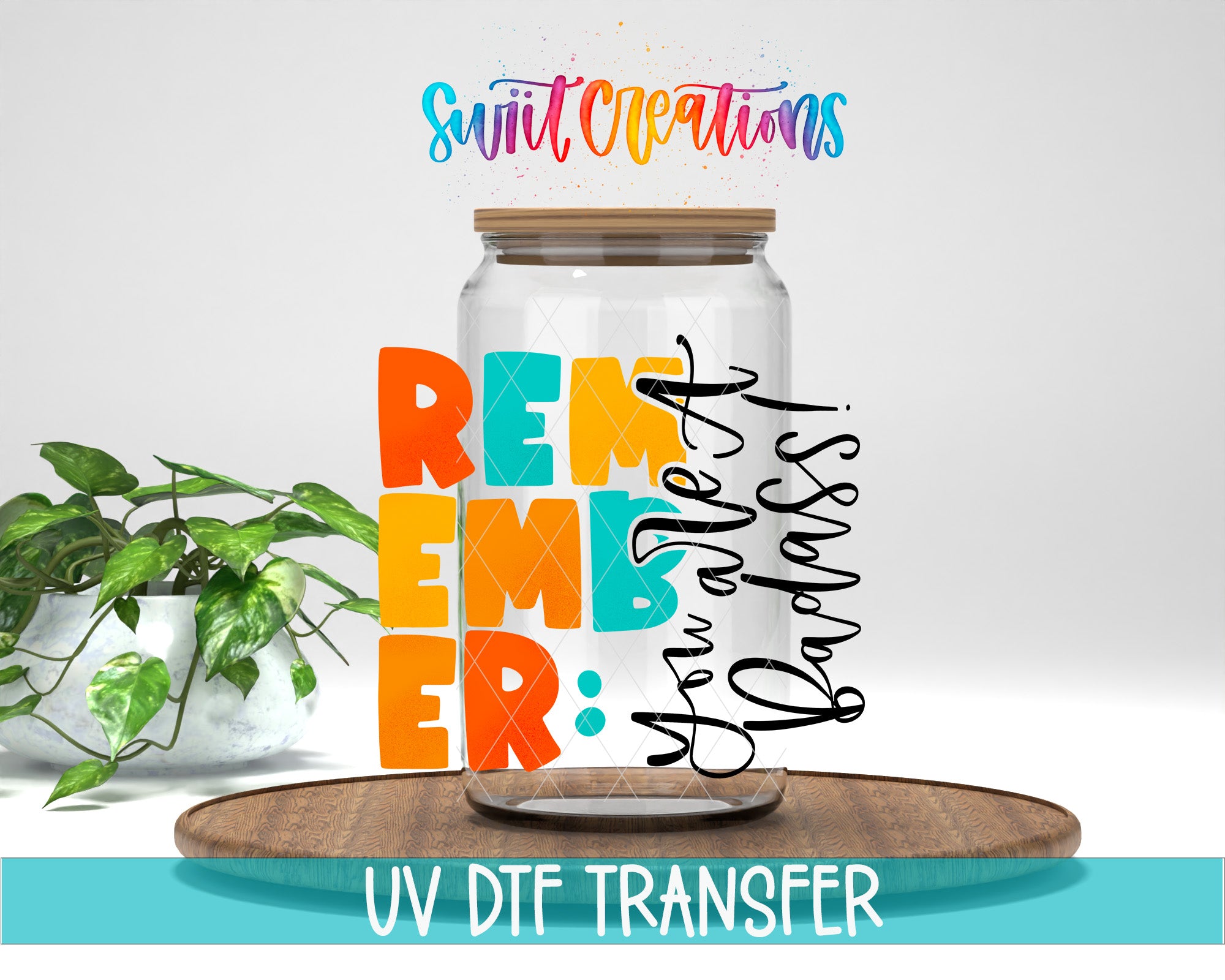 a glass jar with a wooden lid, surrounded by a potted plant and a wooden tray. The jar has a message written on it, and there is text at the bottom of the image that says "UV DFT TRANSFER".