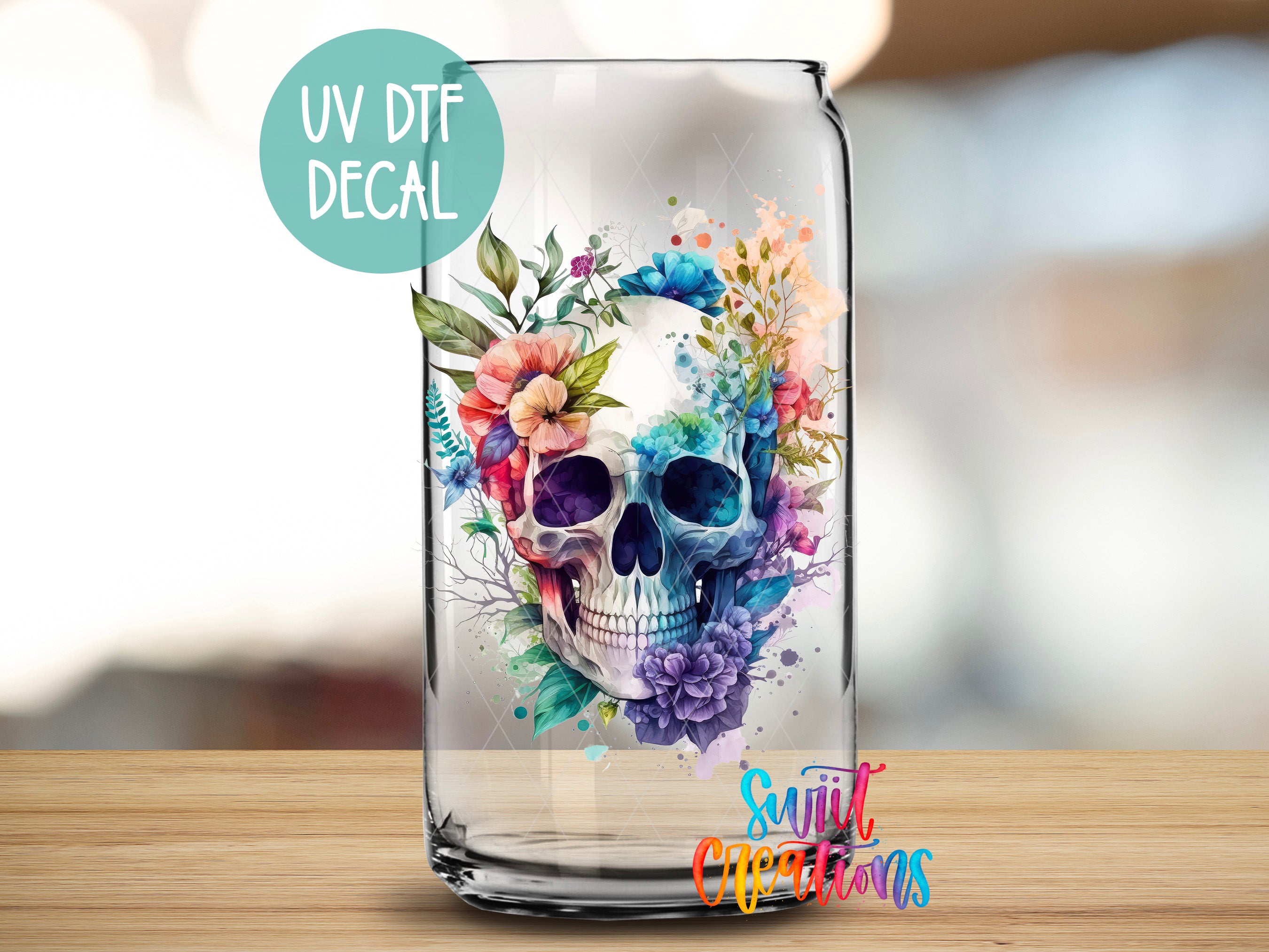 a glass with a skull and flowers painted on it