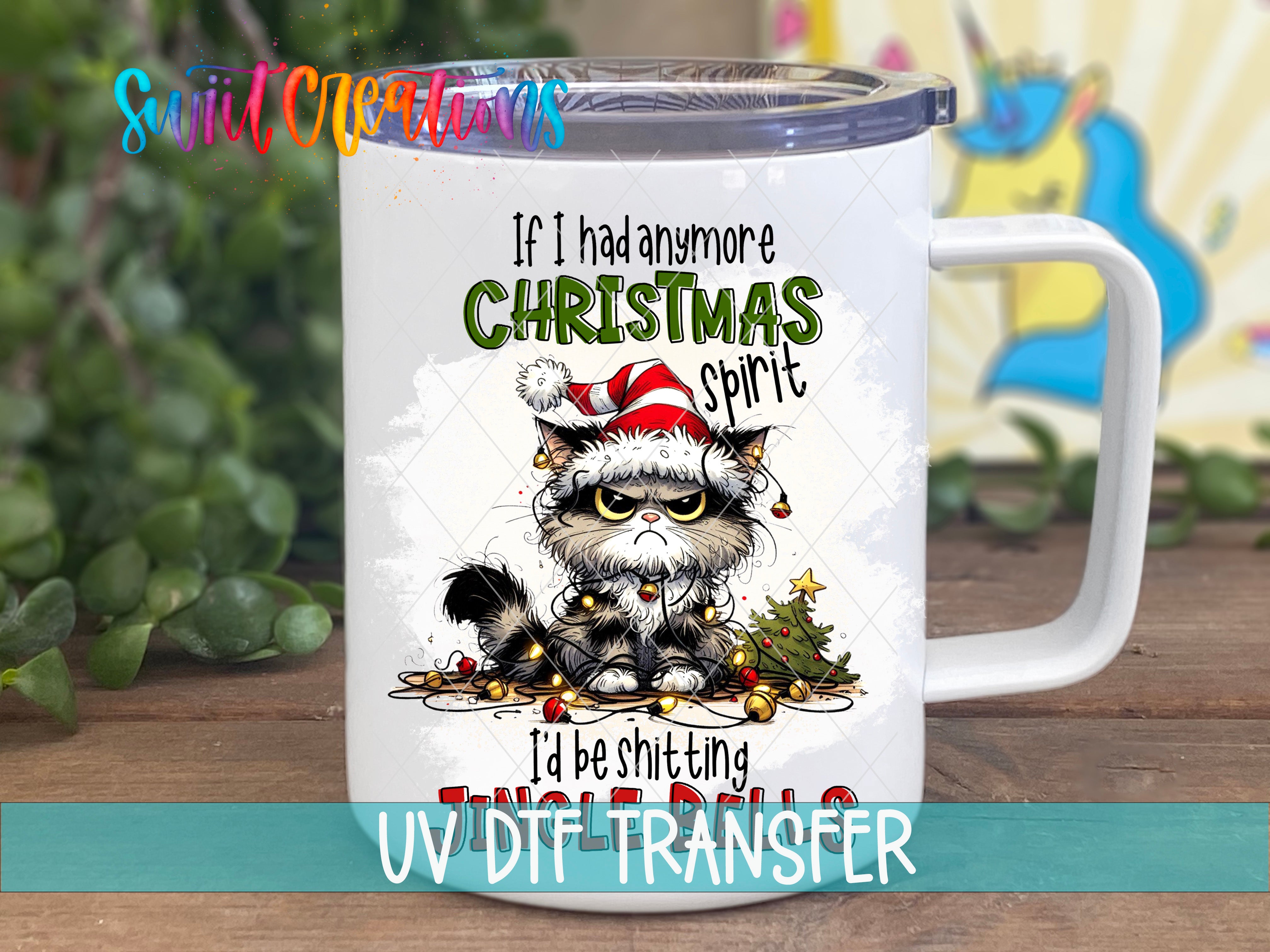 A mug with a cartoon cat wearing a Santa hat and Christmas decorations, along with the text "If I had any more Christmas spirit I'd be shitting JUNK" and "UV DIT FER" printed on it.