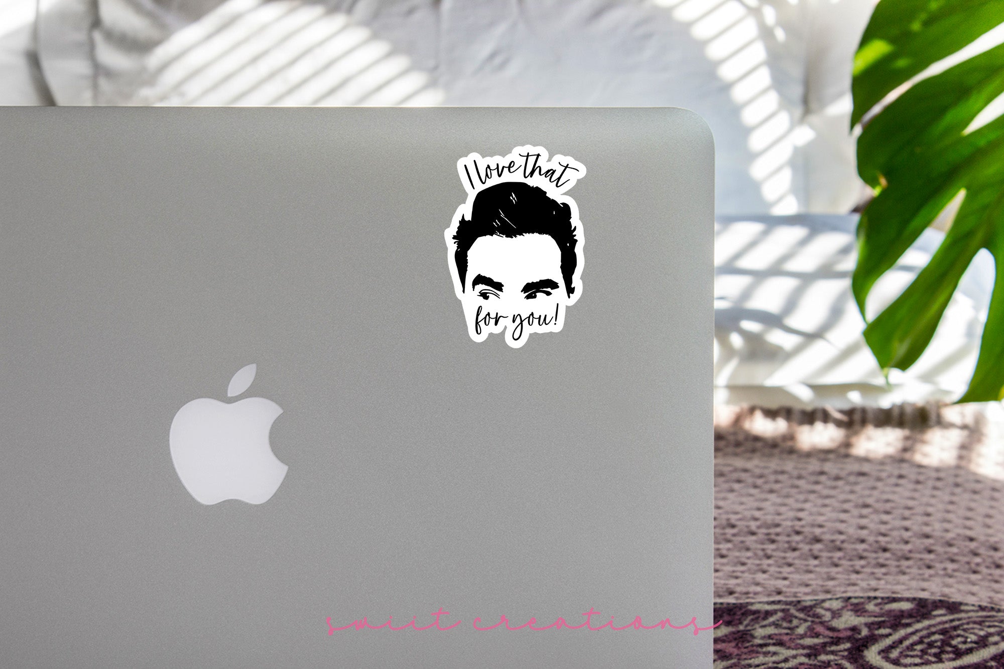 a laptop with a sticker of a man's face