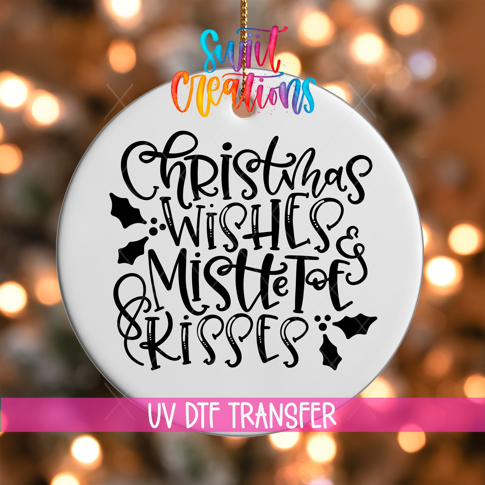 A white ornament with black text that says "Christmas Wishes & Mistle Toes Kisses" hanging on a string.