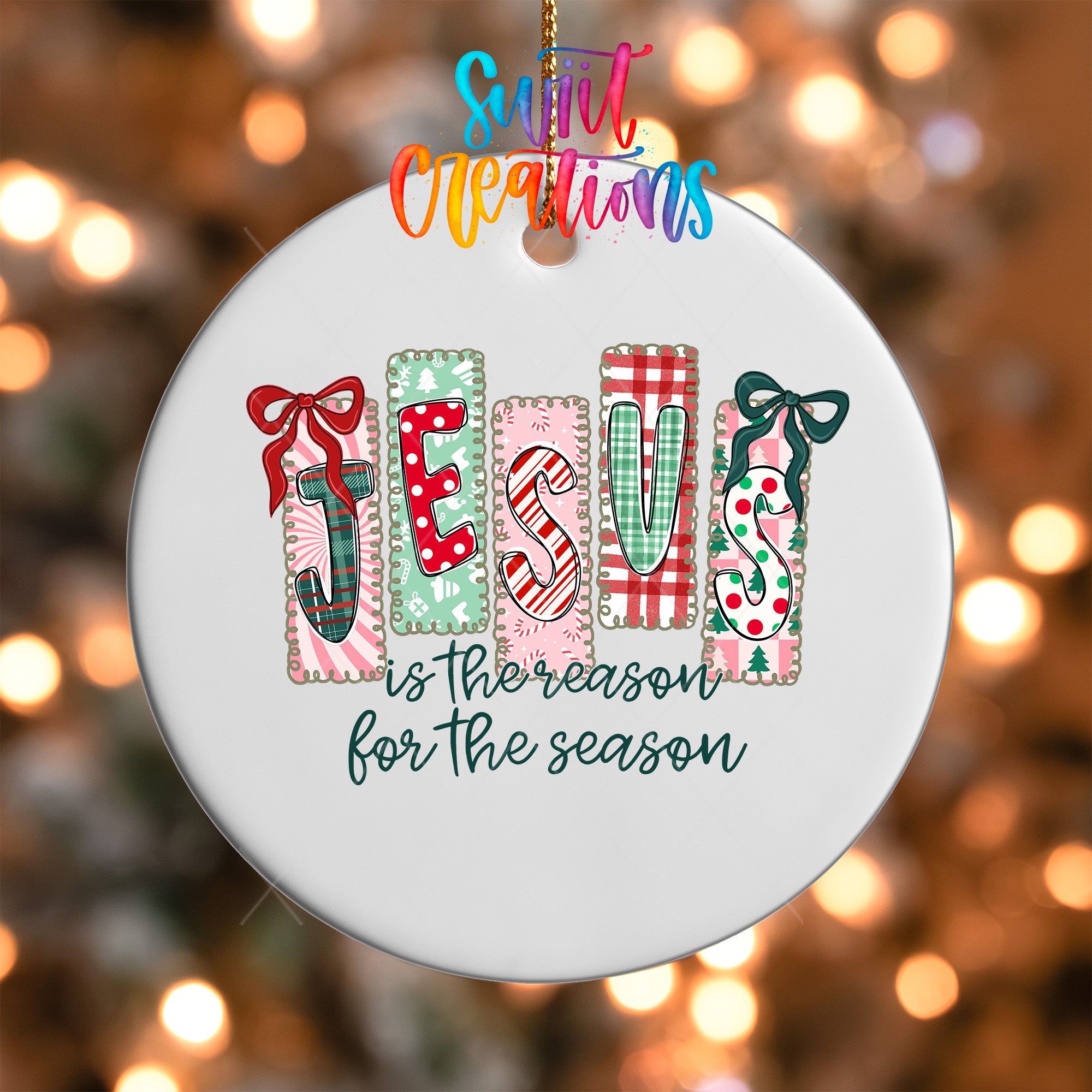 A white ornament with the word "JESUS" spelled out in colorful letters, surrounded by festive holiday decorations such as bows and snowflakes.